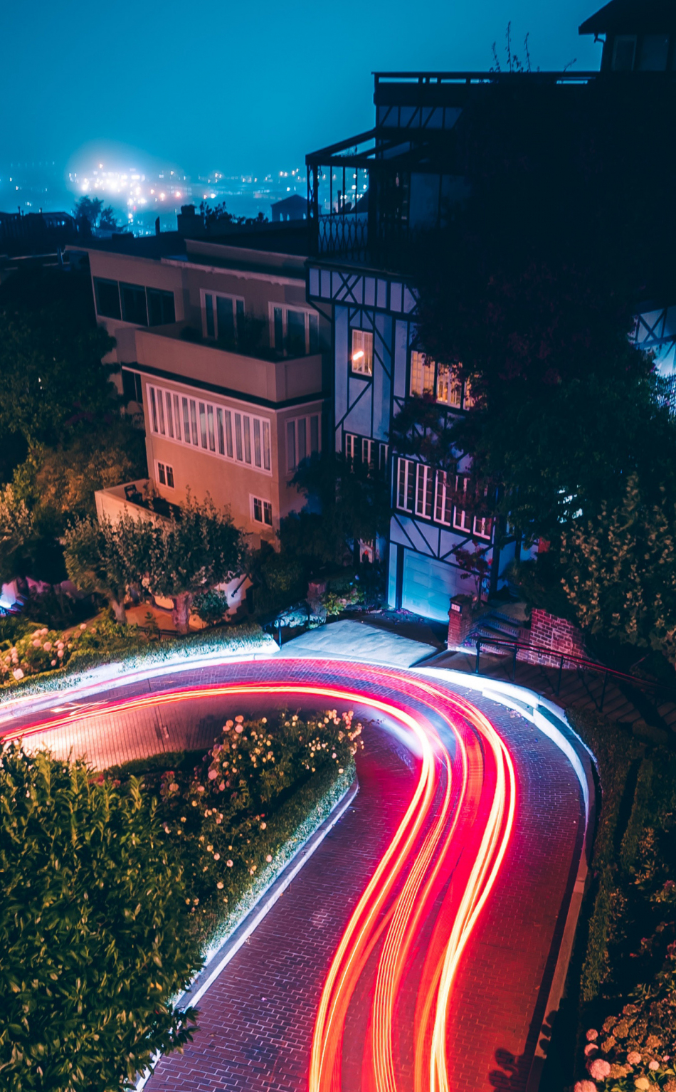 Download wallpaper 950x1534 city, night, road turn, traffic lights, lights trail, iphone, 950x1534 HD background, 18347