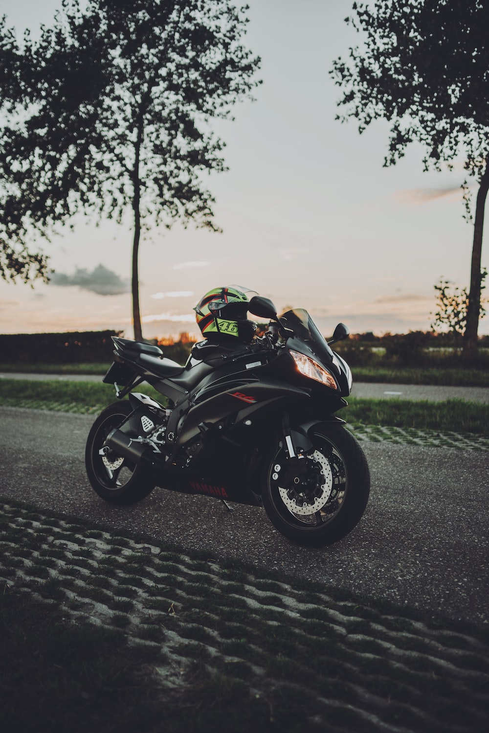 Black sports bike parked on road during daytime photo