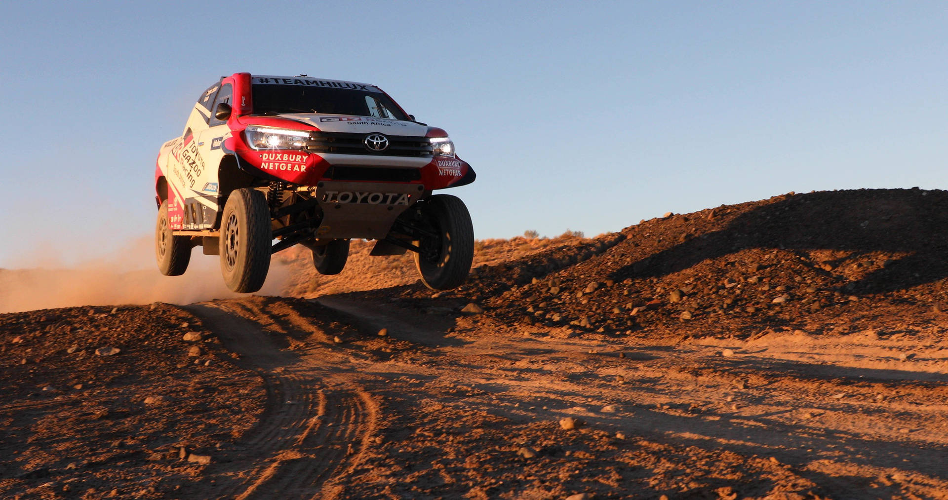 Download Thrilling Performance by Team Hilux at the Dakar Rally Wallpaper