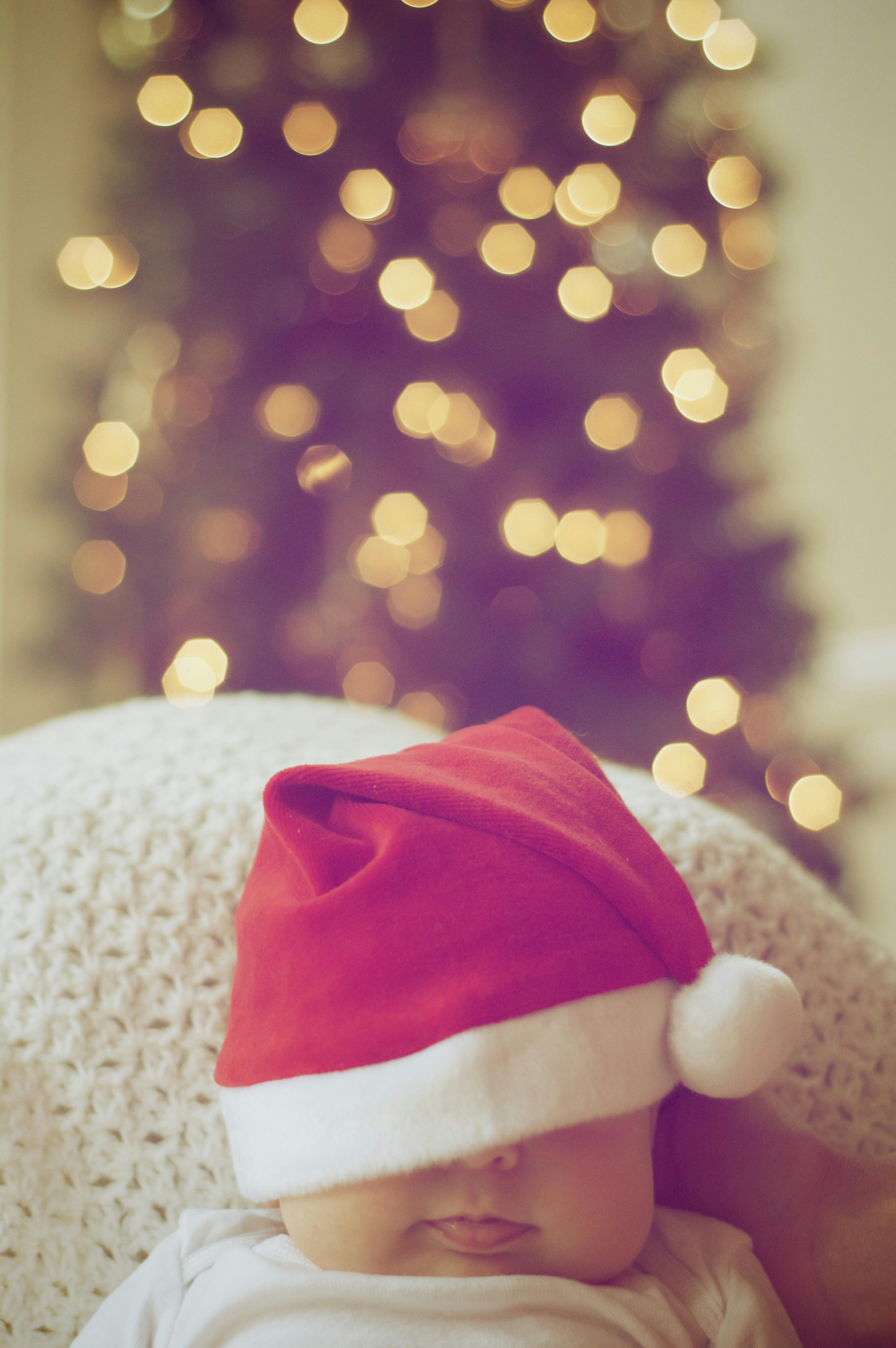 Close Up Of Illuminated Christmas Tree And A Baby · Free