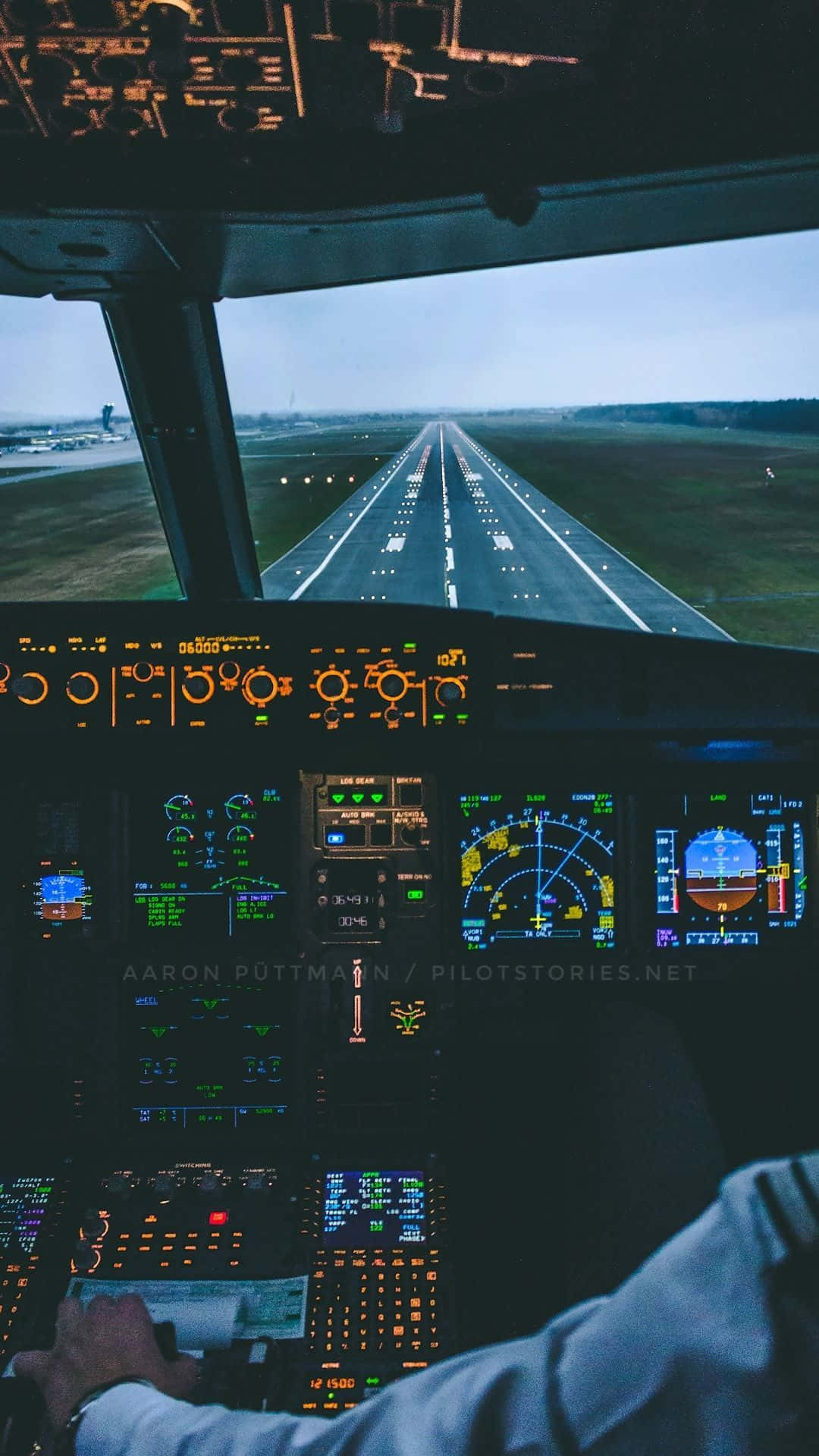 Download A Pilot Is Sitting In The Cockpit Of An Airplane Wallpaper