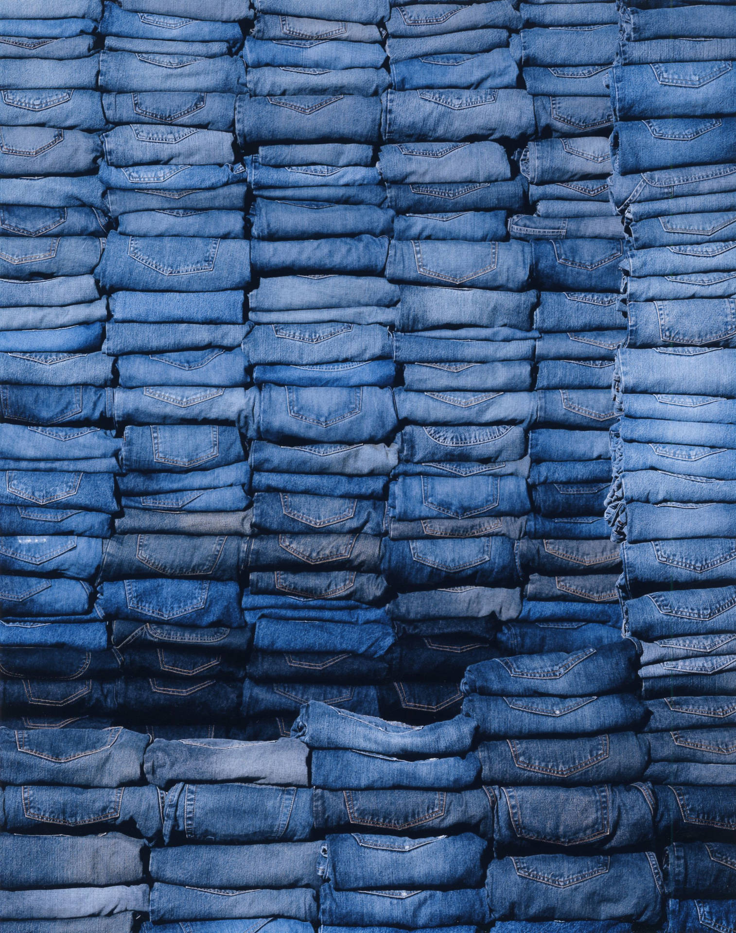 Download Stacks Of Denim Folded Jeans Wallpaper