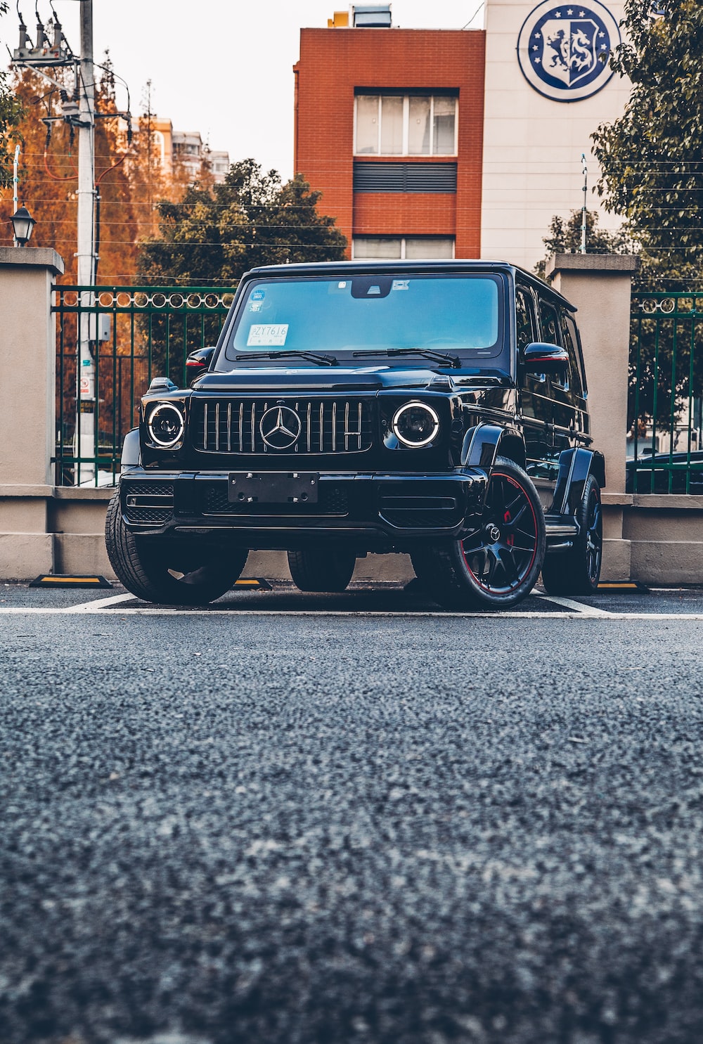 Black mercedes benz g class parked on sidewalk during daytime photo