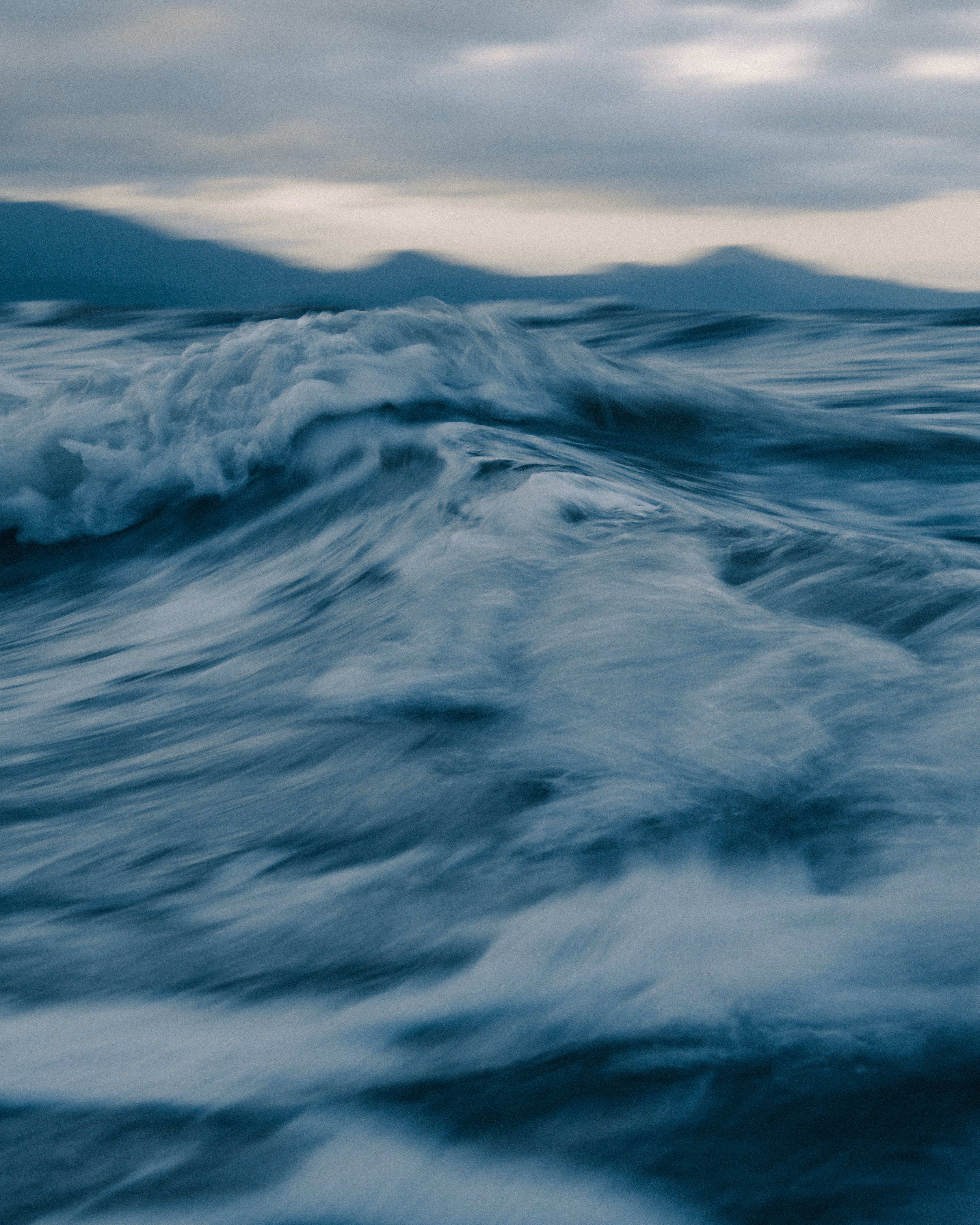 Stormy sea with fast foamy waves at sunset · Free