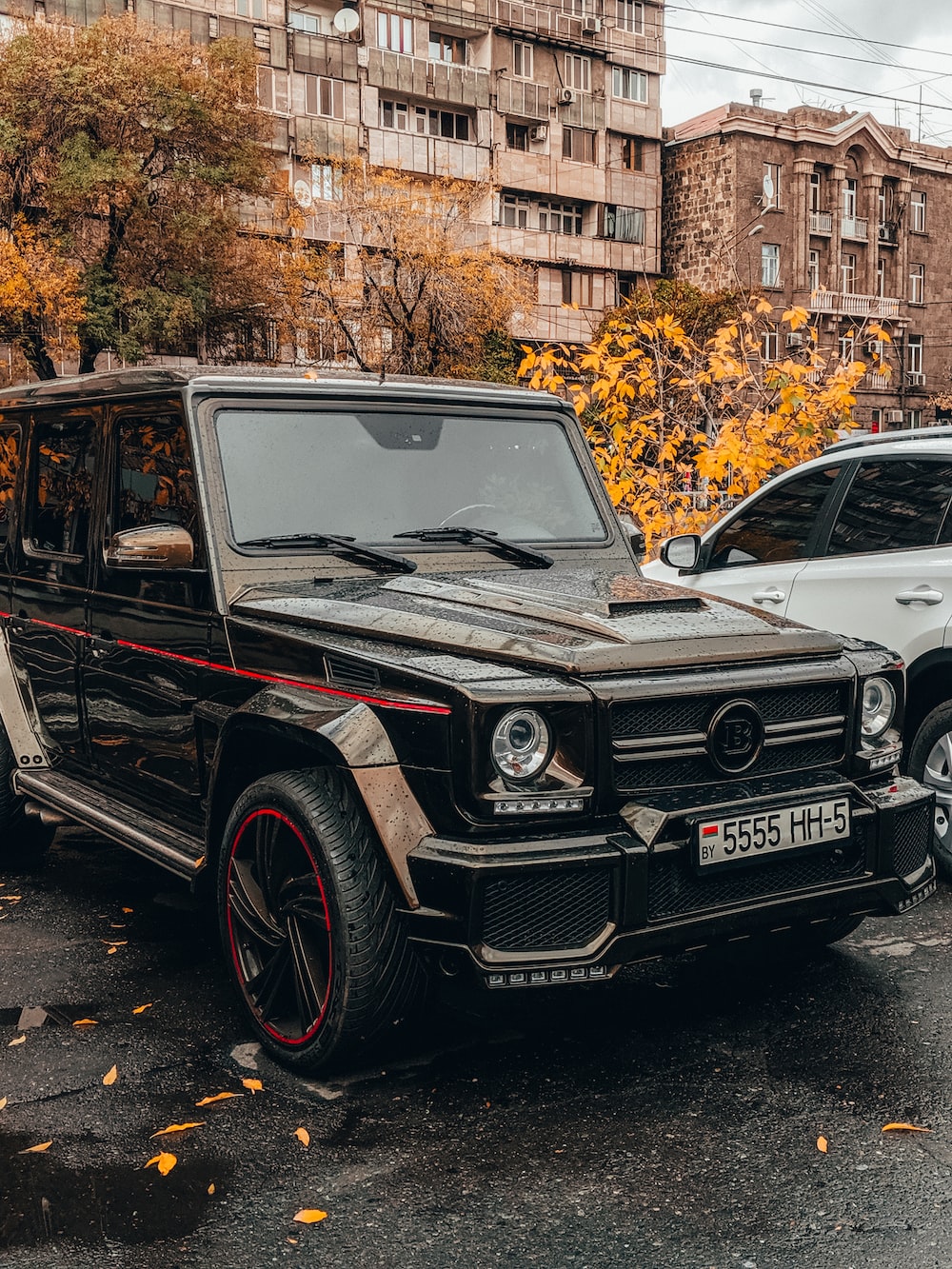 Black mercedes benz g class suv parked on sidewalk during daytime photo