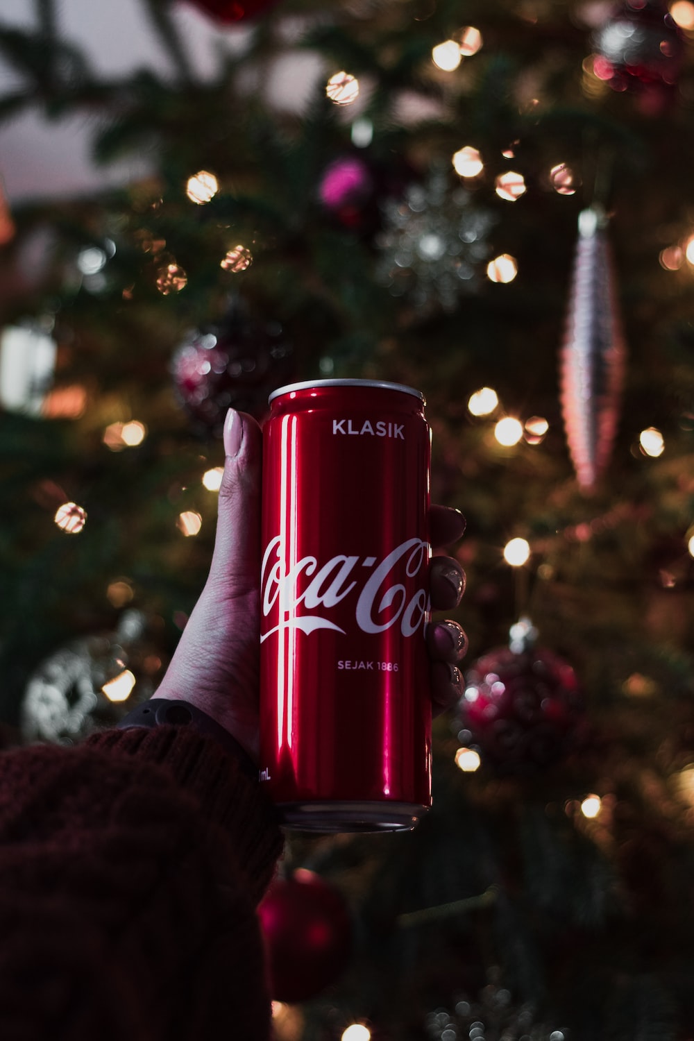 Coca cola cherry can on persons hand photo