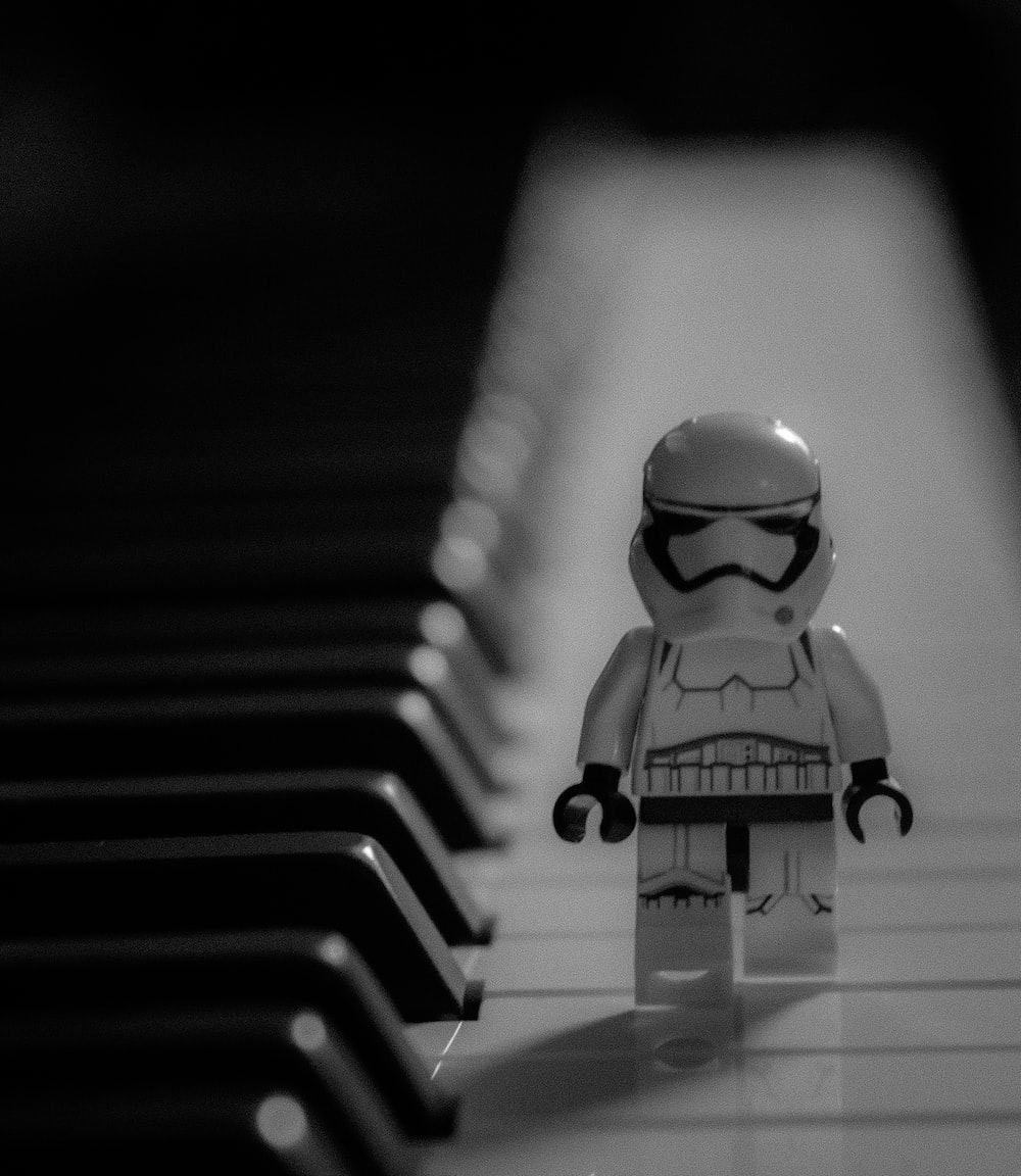 A lego star wars character standing next to a piano photo