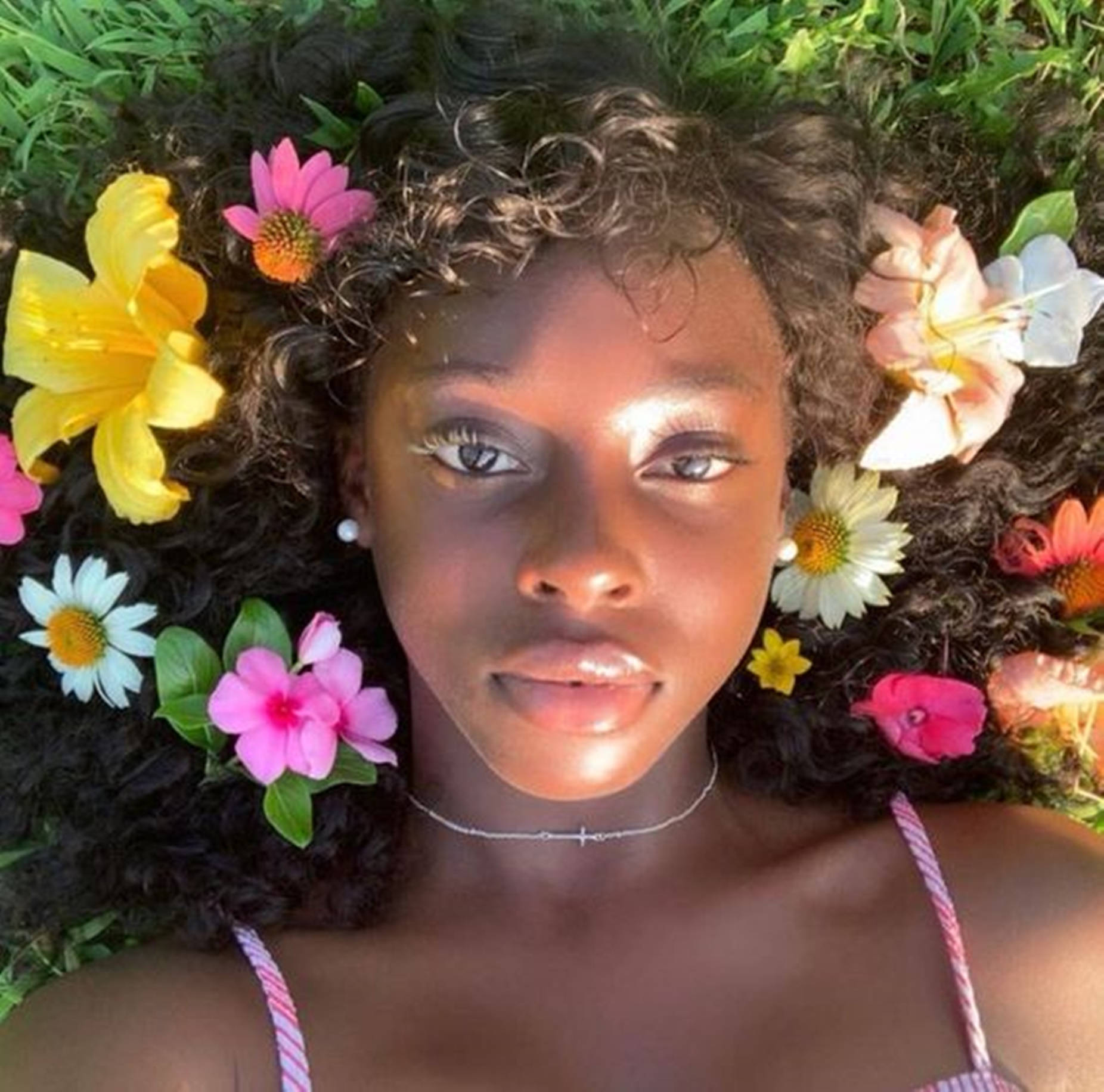 Download Beautiful Black Woman On Flower Field Wallpaper
