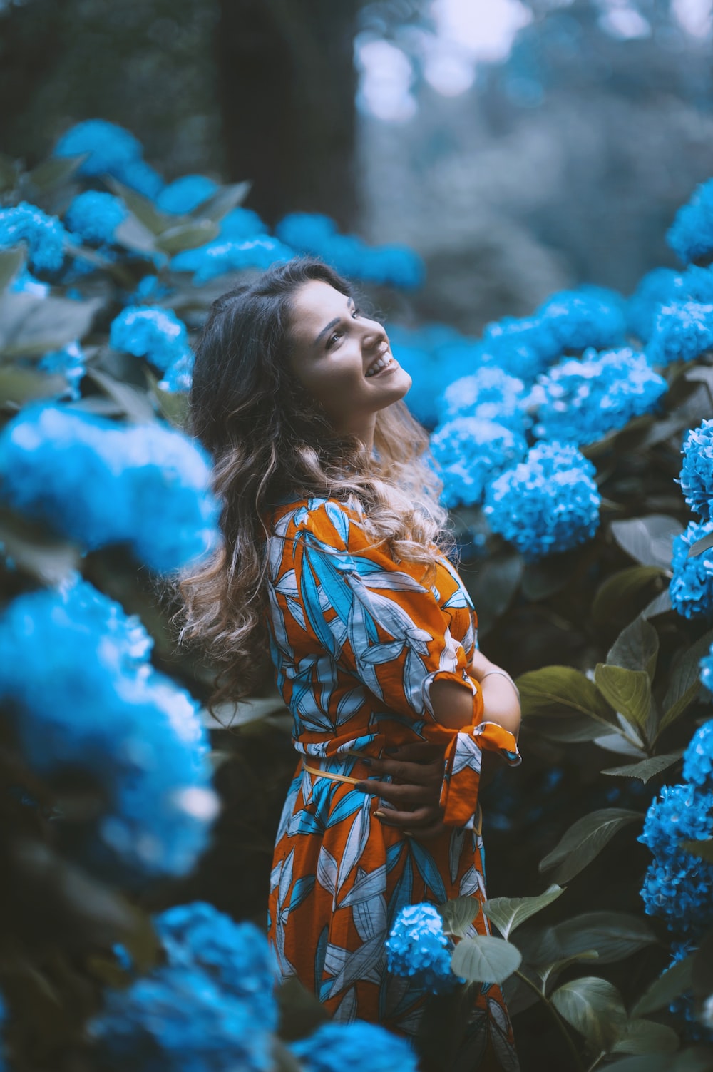 Woman standing infront of flowers photo