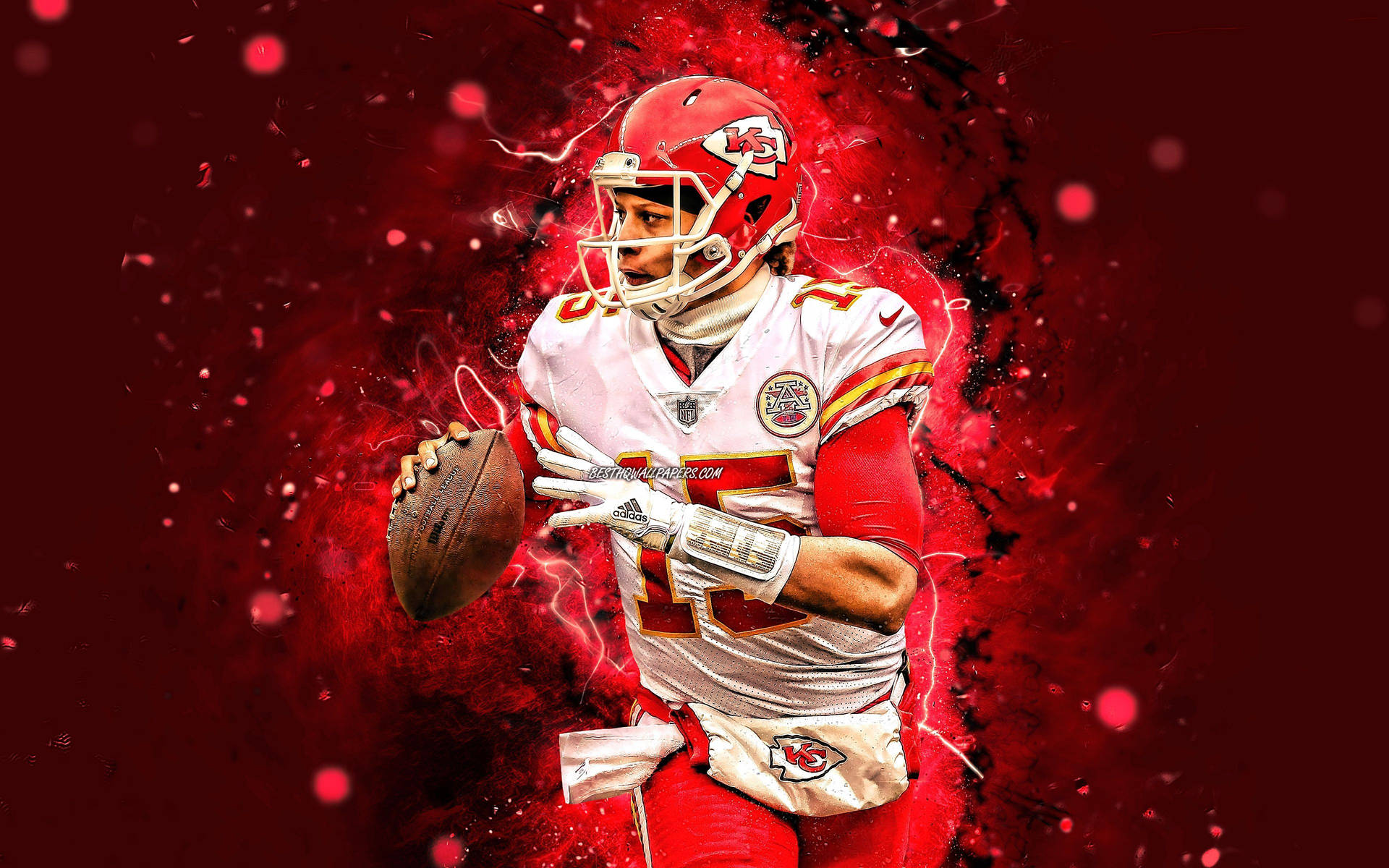 Download A Kansas Chiefs Player Holding A Football Wallpaper