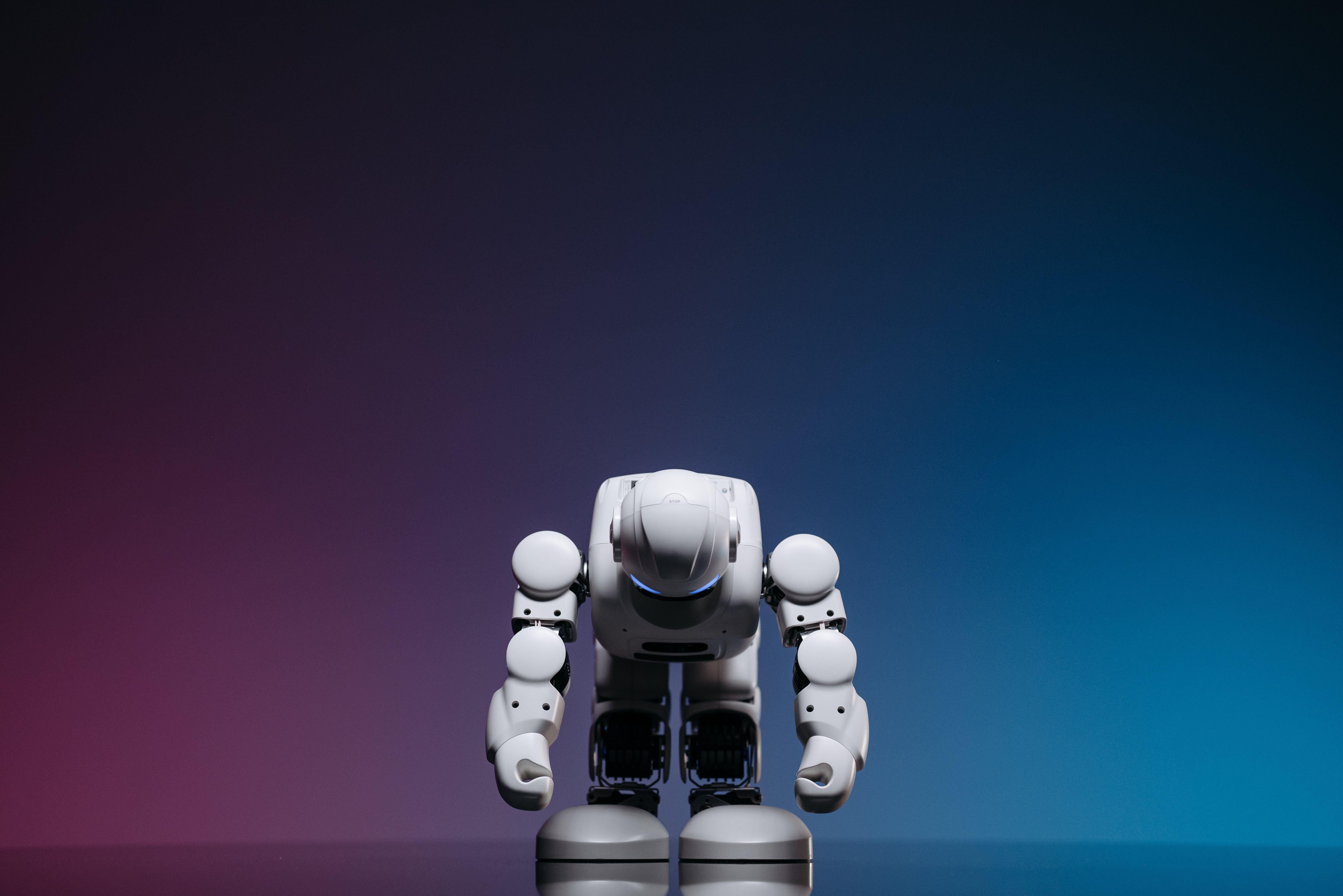 Close Up Shot of White Toy Robot on Blue and Pink Background · Free
