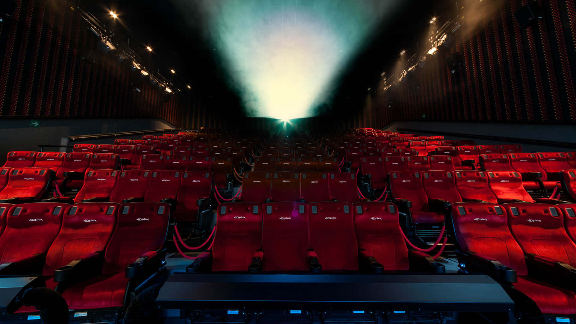 Download A Large Auditorium With Red Seats And A Light Coming From The Ceiling