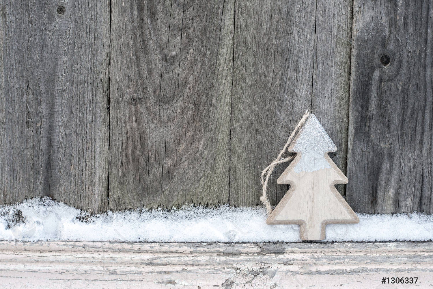 Rustic winter background with wooden Christmas tree and snow on
