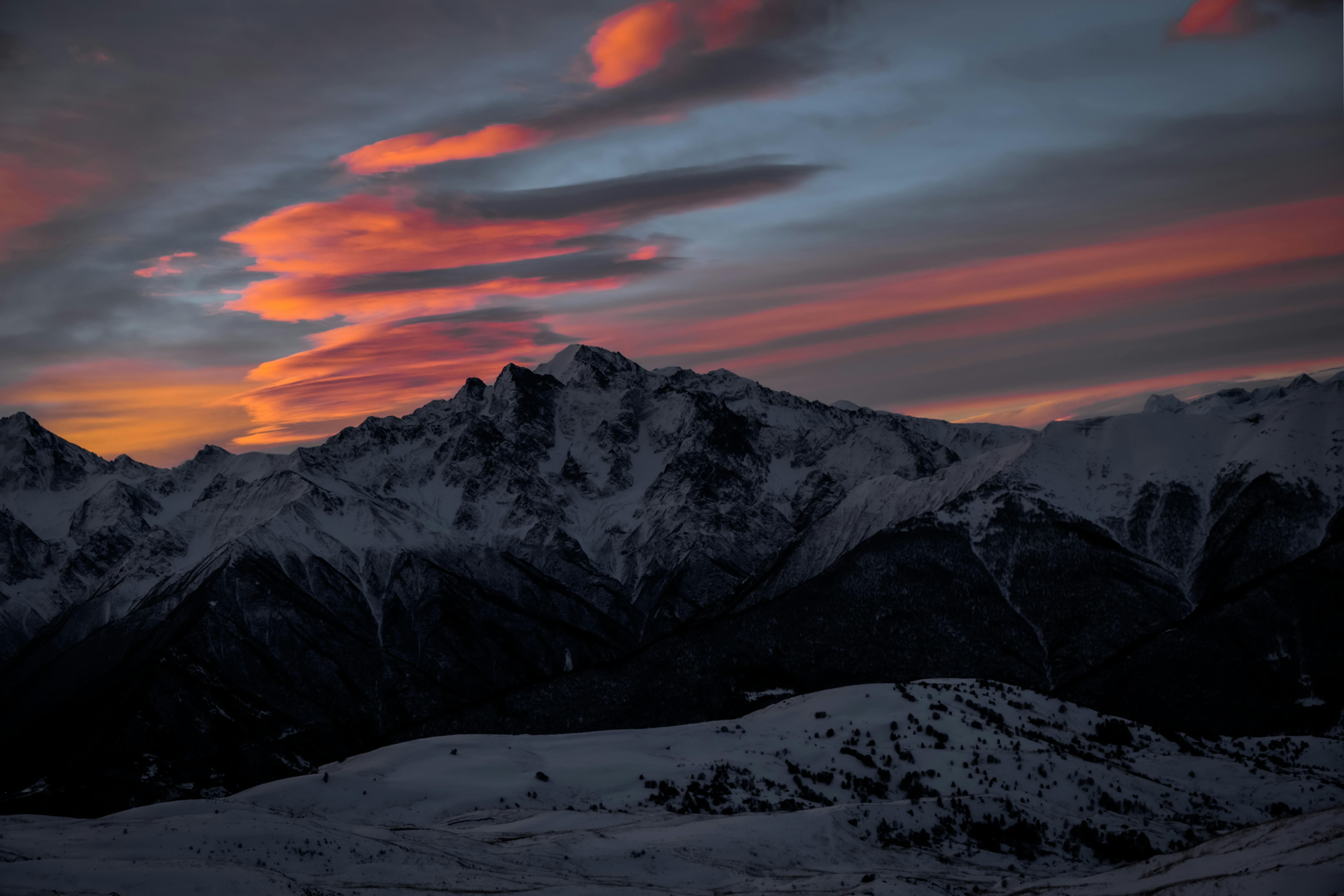 Clouds over Mountains at Sunset · Free