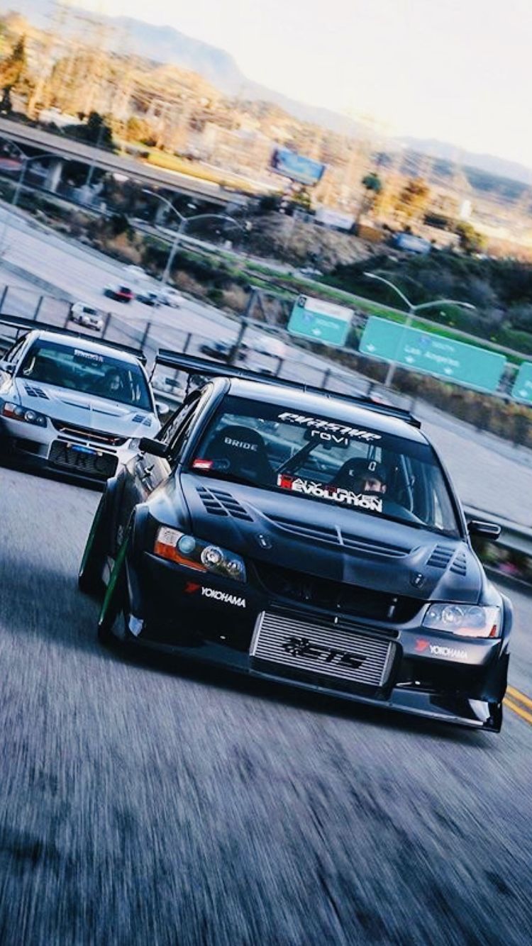 Two 2006 Mitsubishi Lancer Evolution IXs Racing