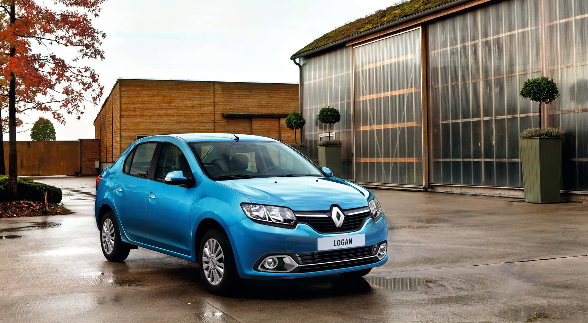 Download Sleek Dacia Logan Cruising On The Highway Wallpaper