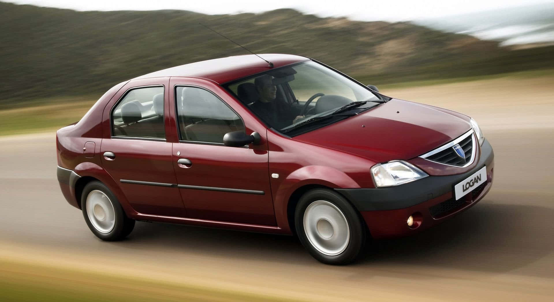Download Sleek Dacia Logan In An Off Road Adventure Wallpaper