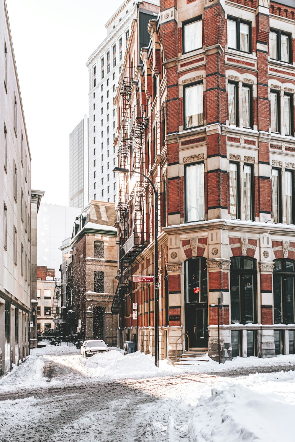A snowy street in a large city with tall buildings photo
