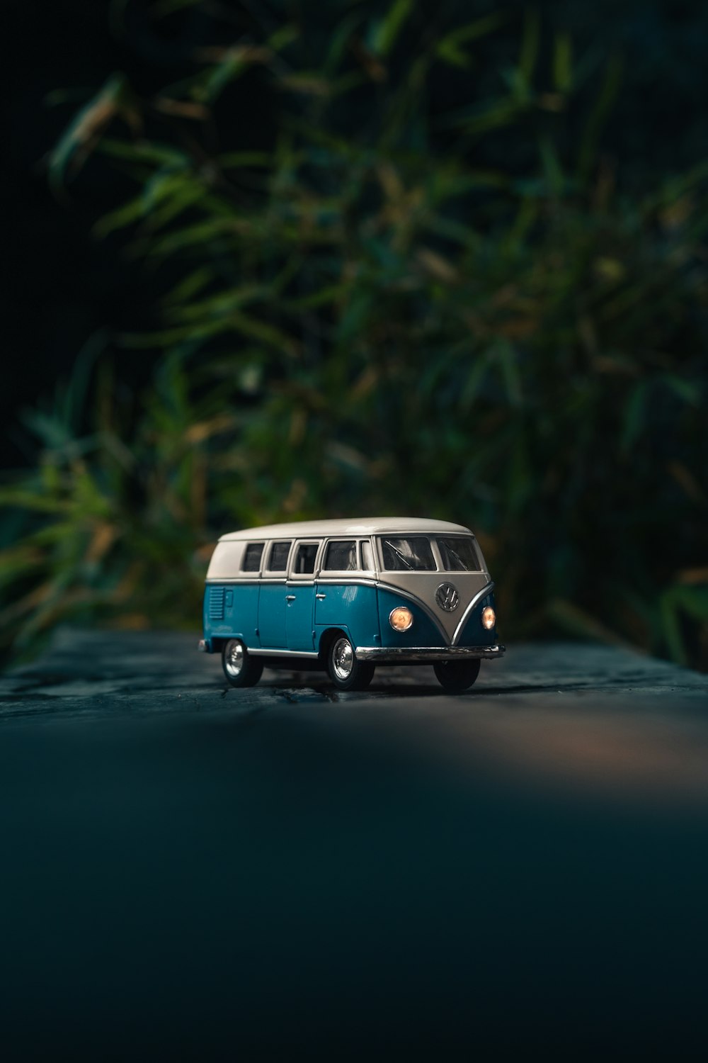 White and blue Volkswagen T1 van toy on gray surface photo
