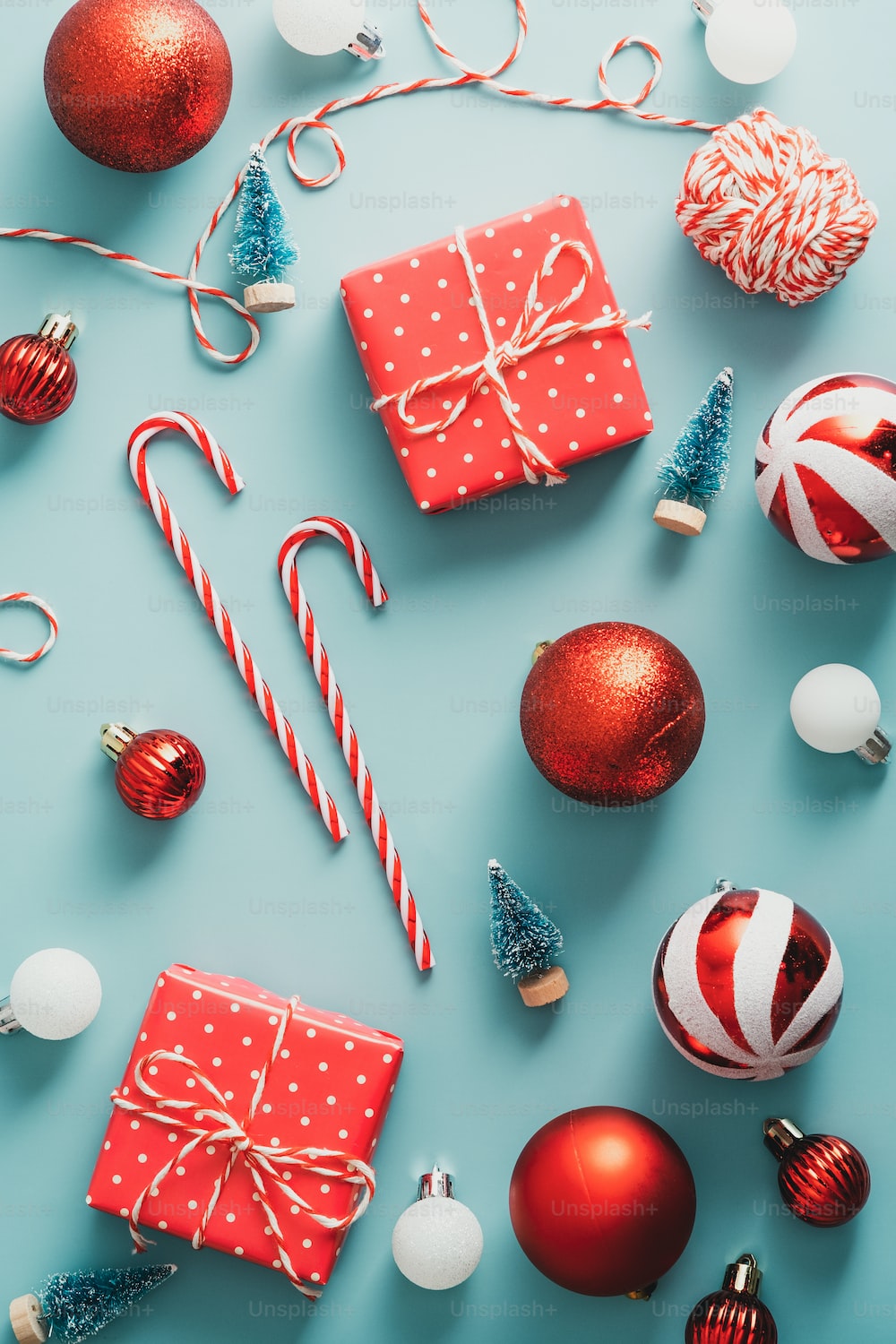 Flat lay composition with vintage Christmas decorations, gift boxes, candy canes on green background. Happy Christmas