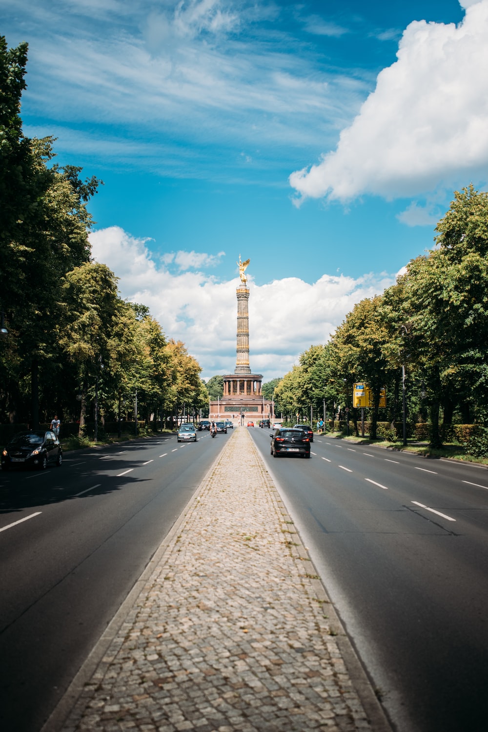 A street with cars and a monument in the background photo