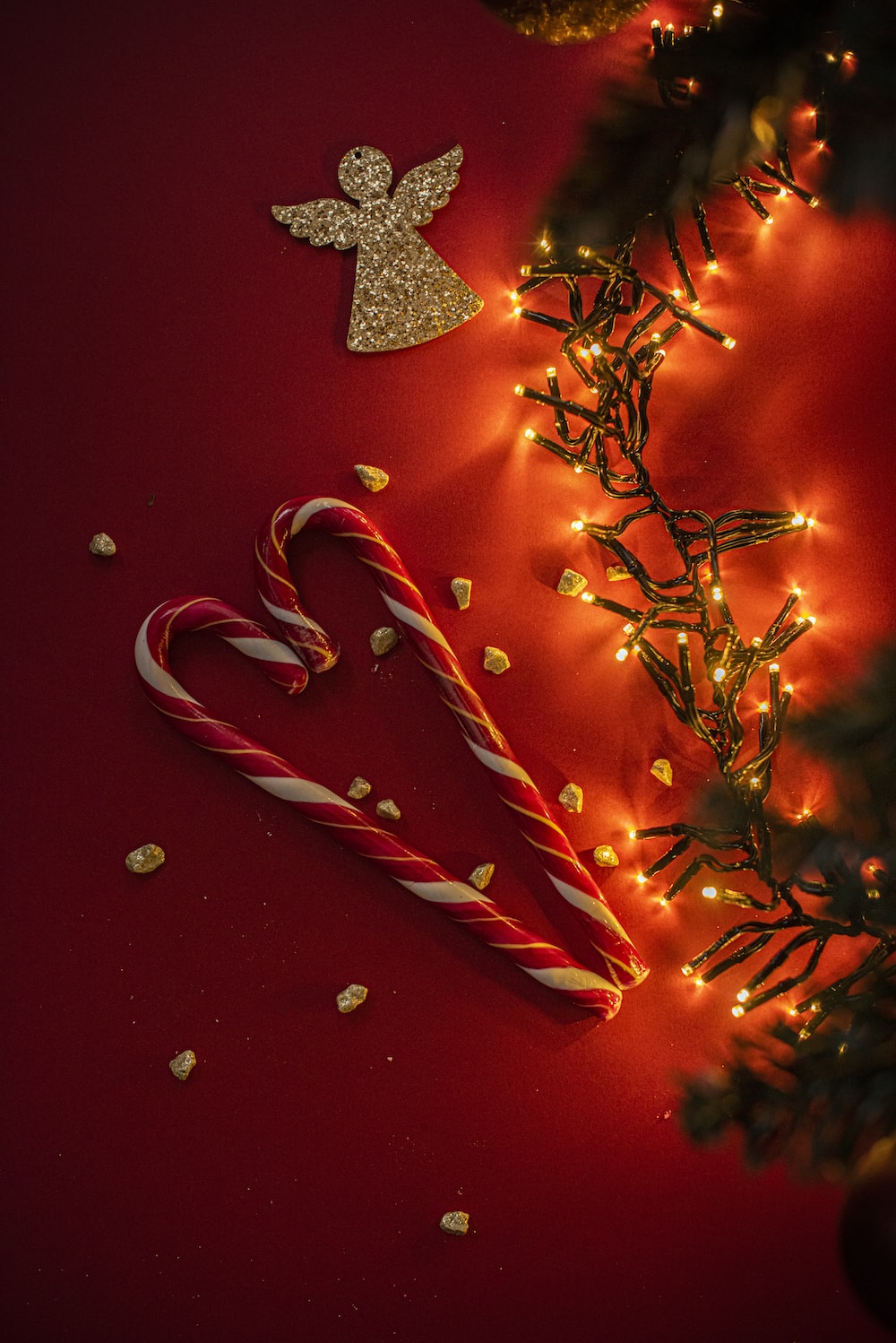 Red and white candy cane on red and white christmas tree photo
