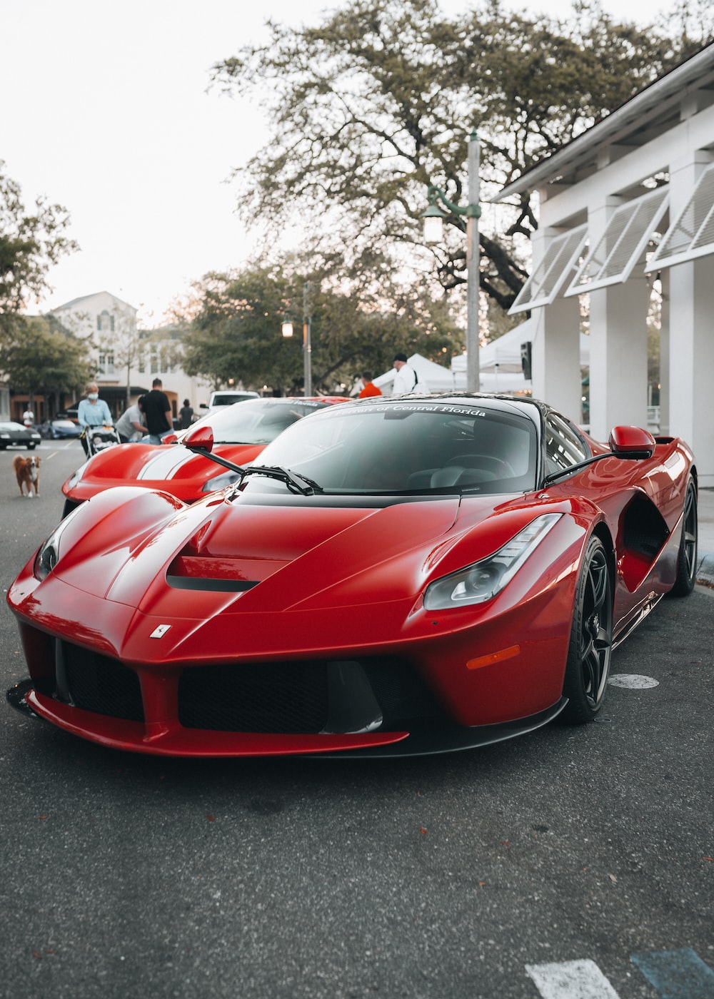 Red ferrari 458 italia parked on parking lot during daytime photo