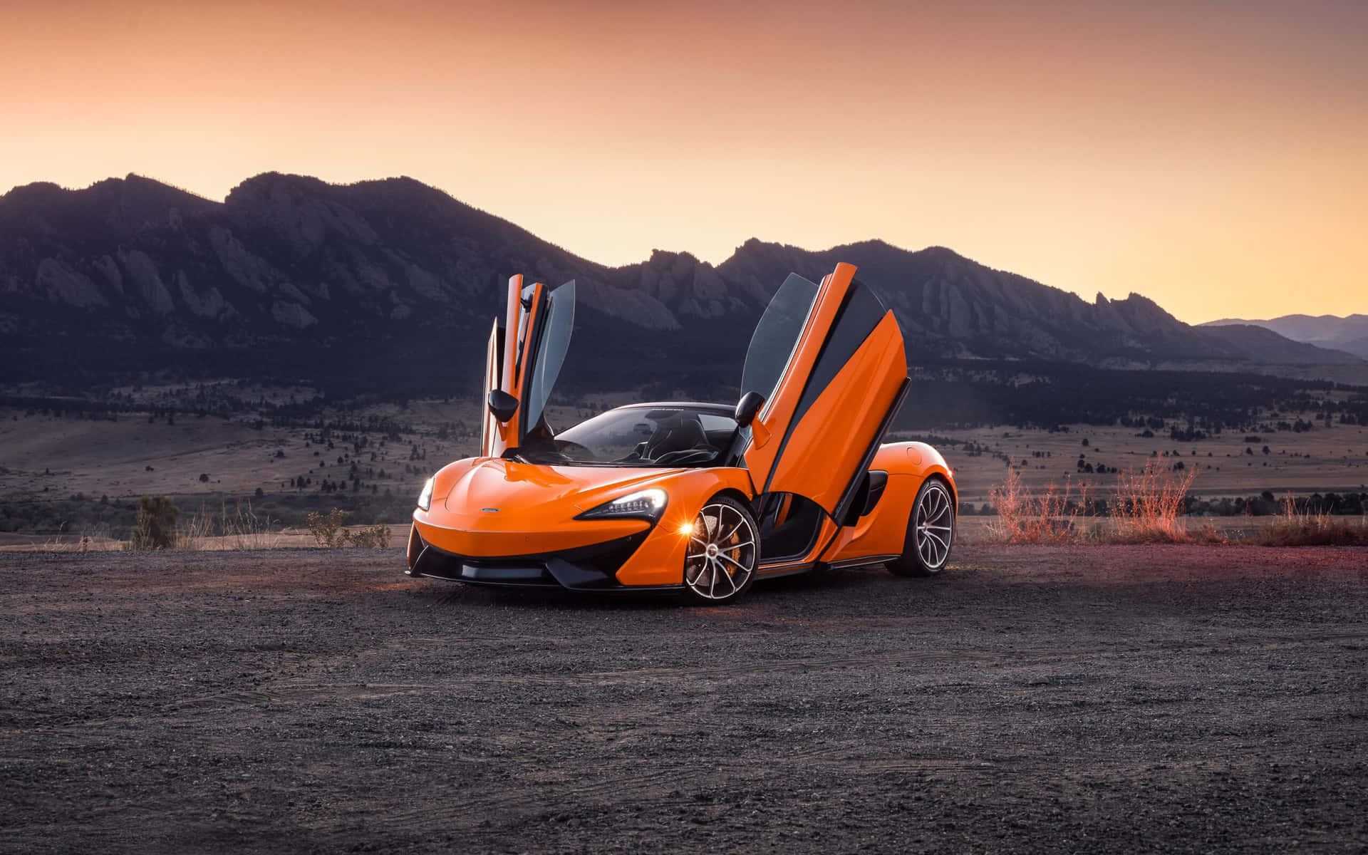 Download A stunning orange McLaren sports car on the road