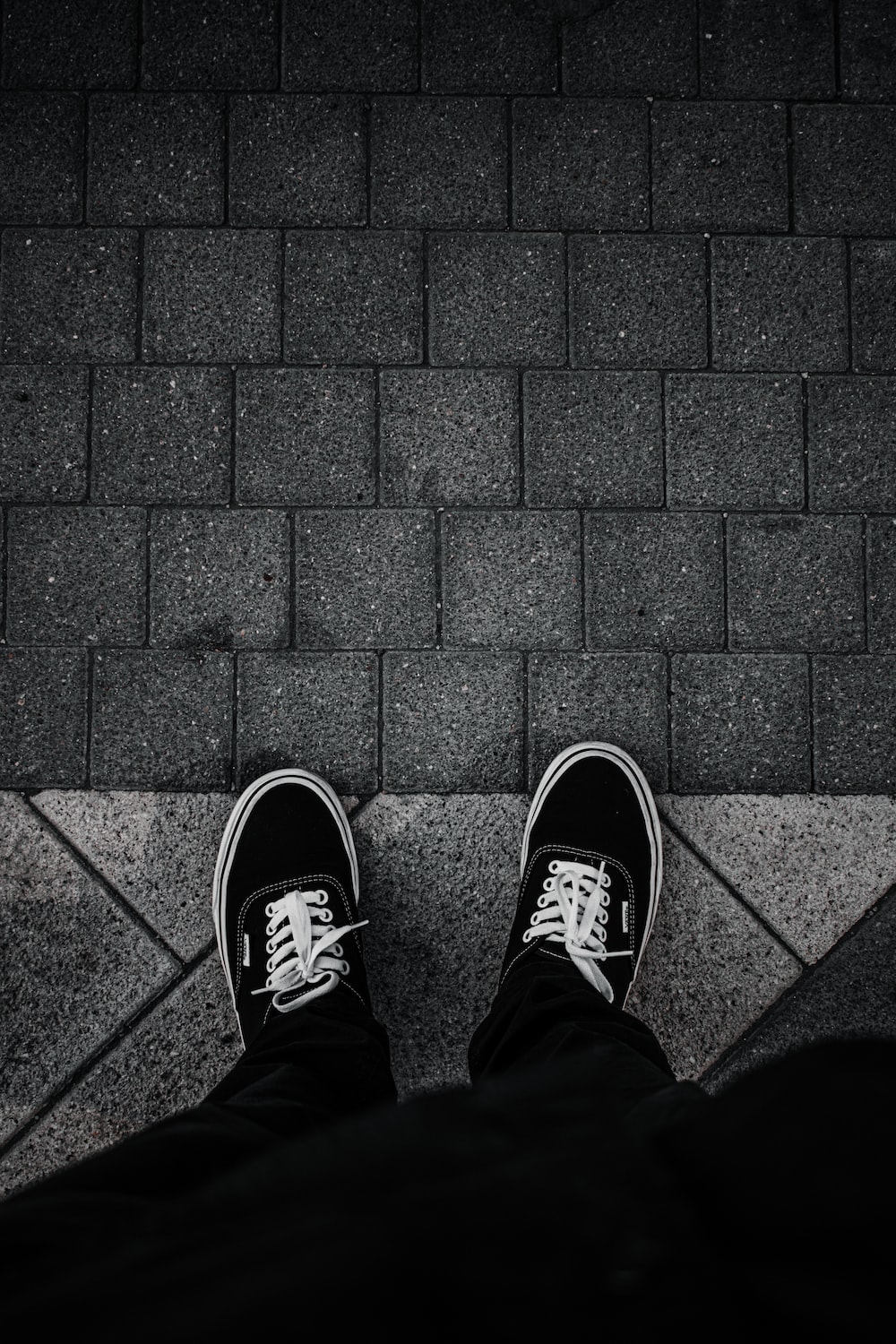 Person in black and white sneakers photo