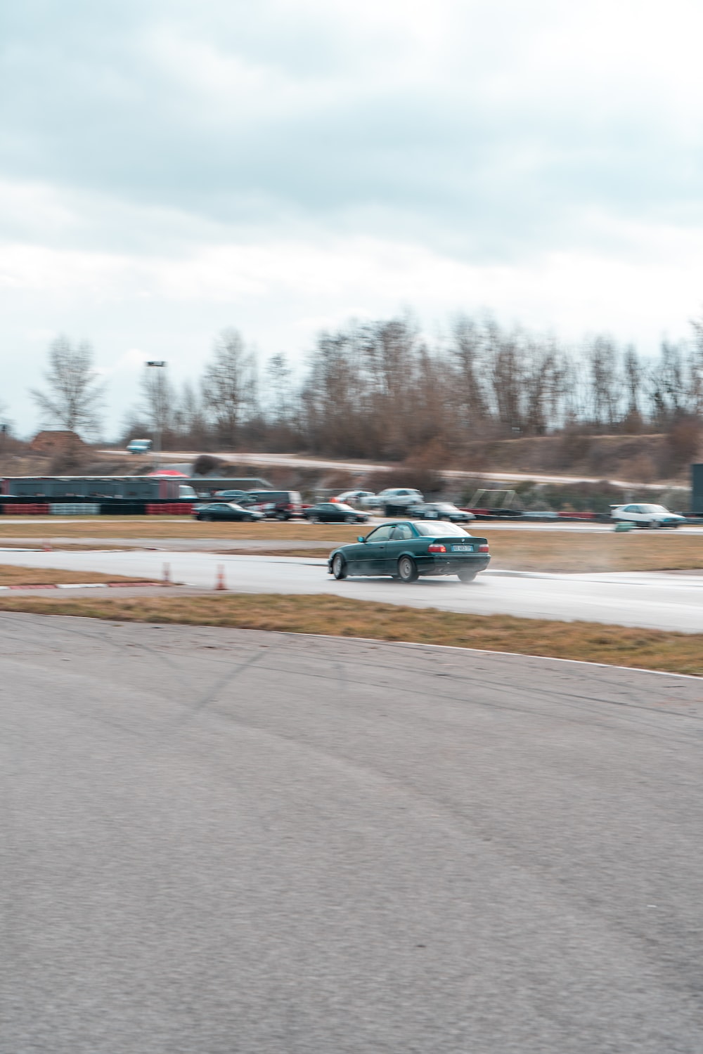 A car driving down a race track with a sky background photo