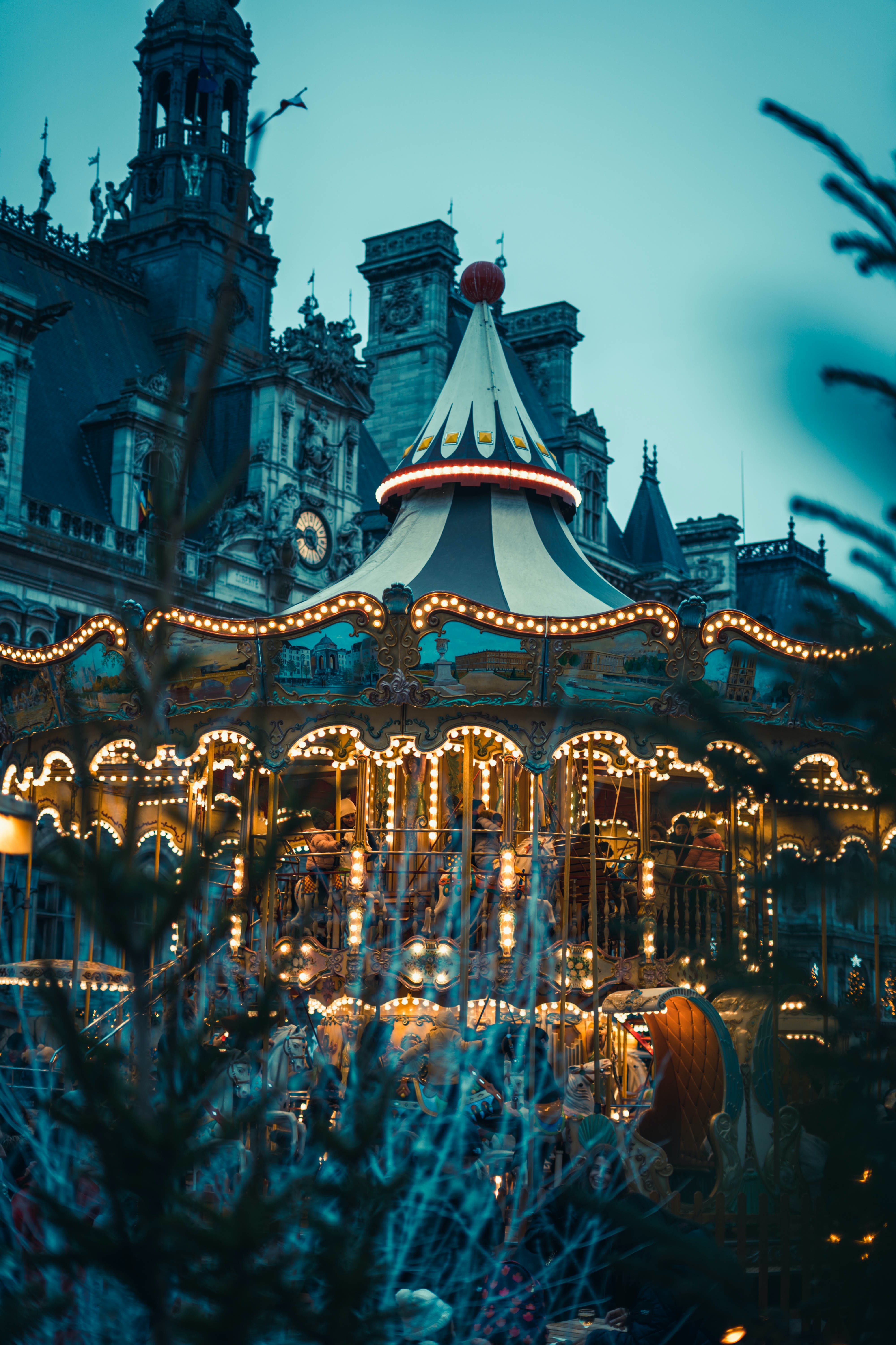 A Christmas Carousel in front of a Building in Marais, Paris, France · Free