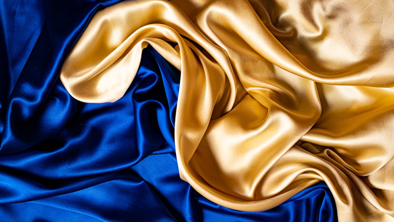 Close Up Shot Of A Blue And Gold Colored Silk Cloth · Free