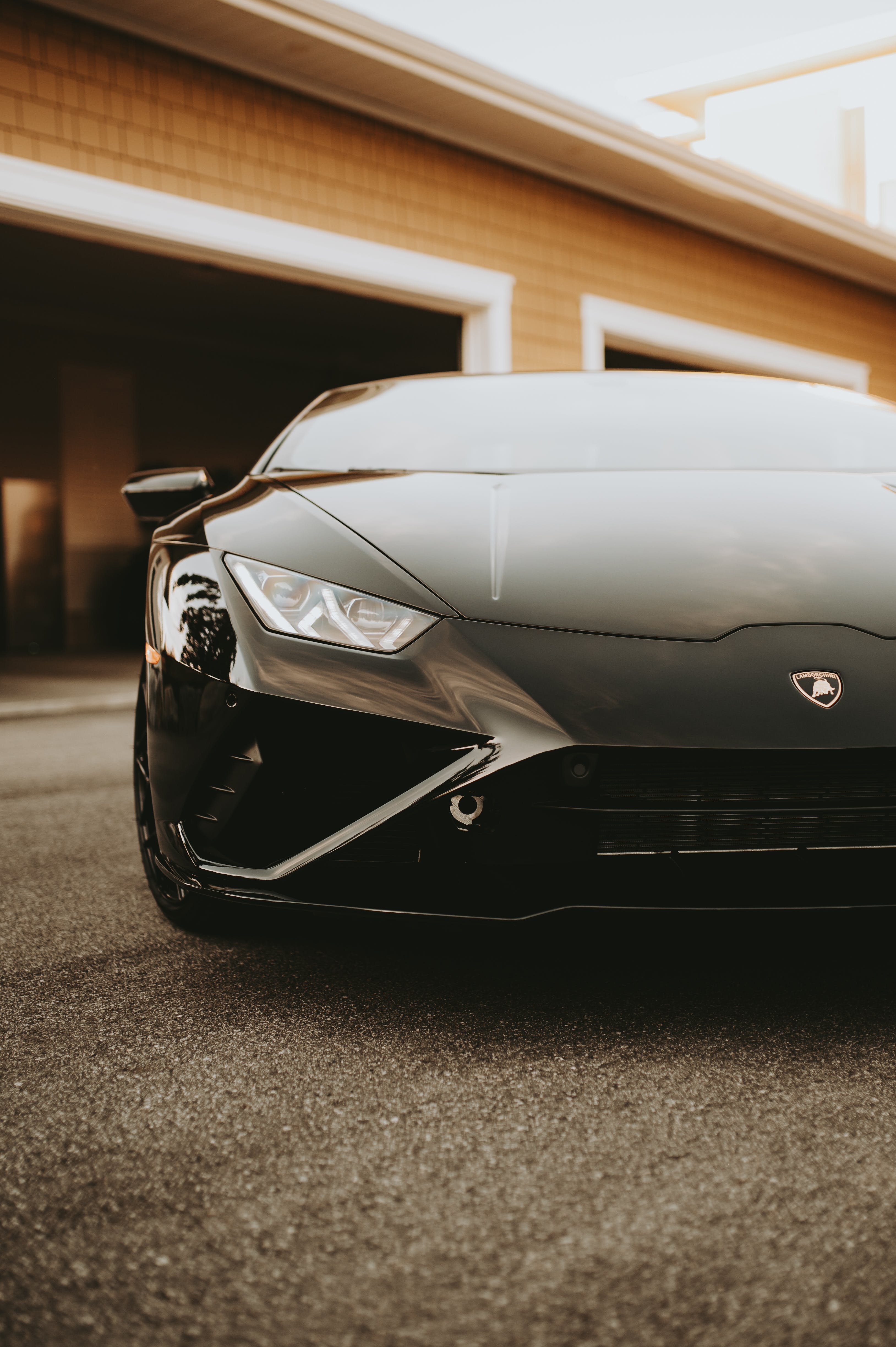 Black Lamborghini Parked Beside a Garage · Free