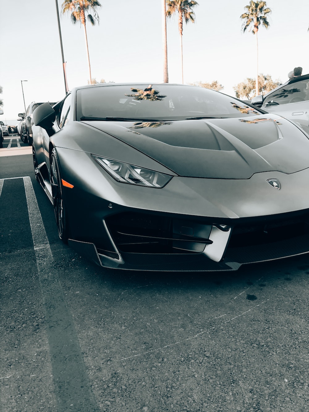 Black lamborghini aventador parked on parking lot during daytime photo