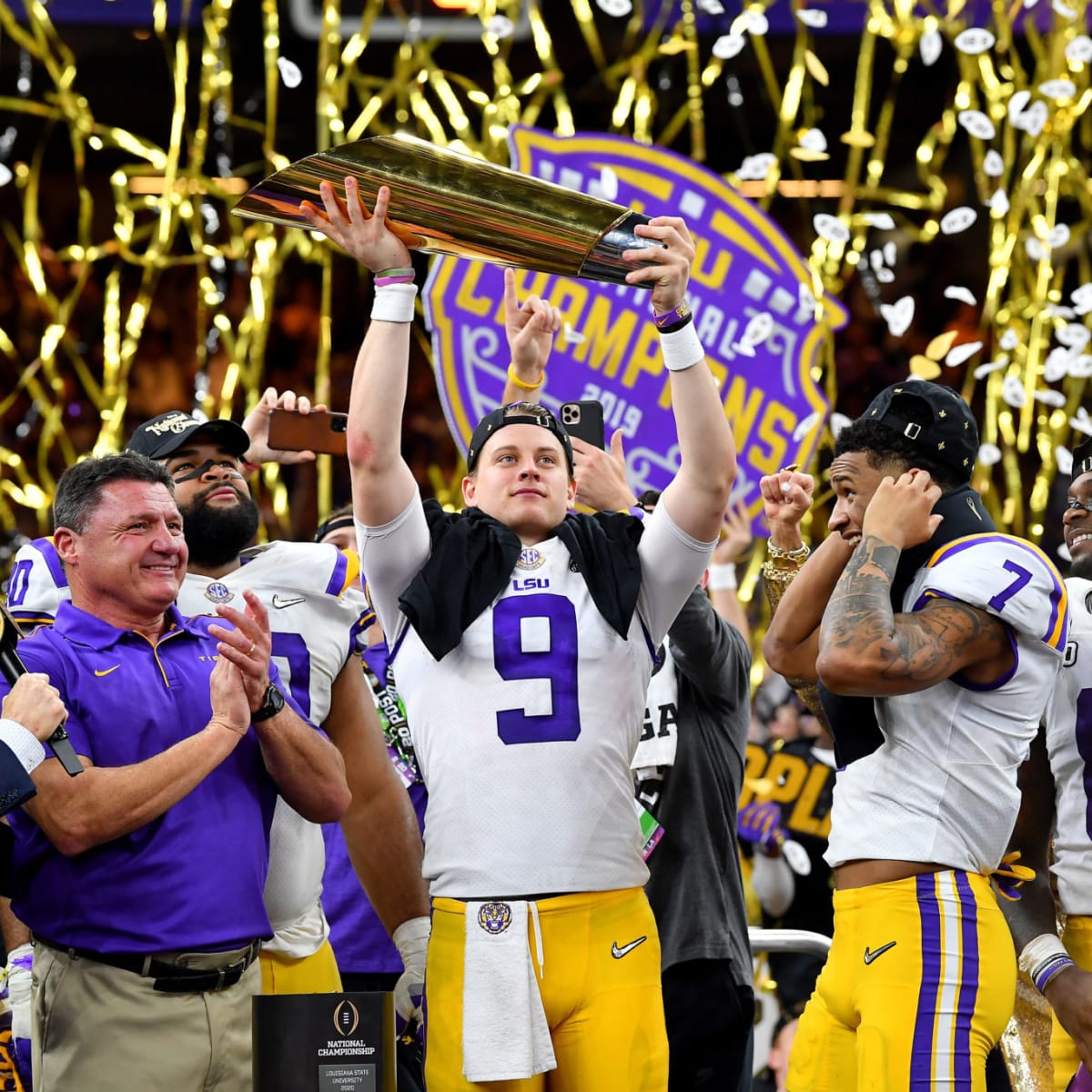 Joe Burrow LSU Tigers Unsigned White Jersey Posting LSU Sticker on National Championship Bracket Photograph