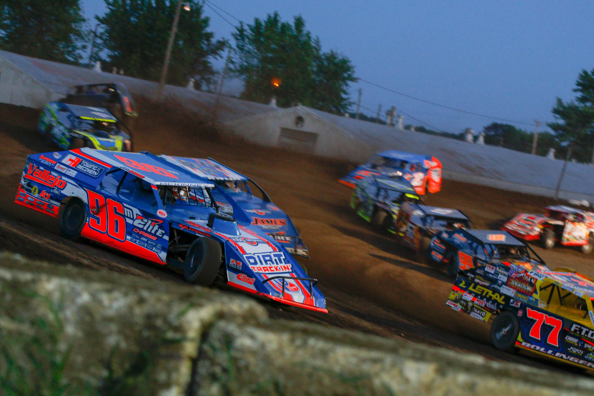Download Dirt Cars Racing On A Dirt Track Wallpaper