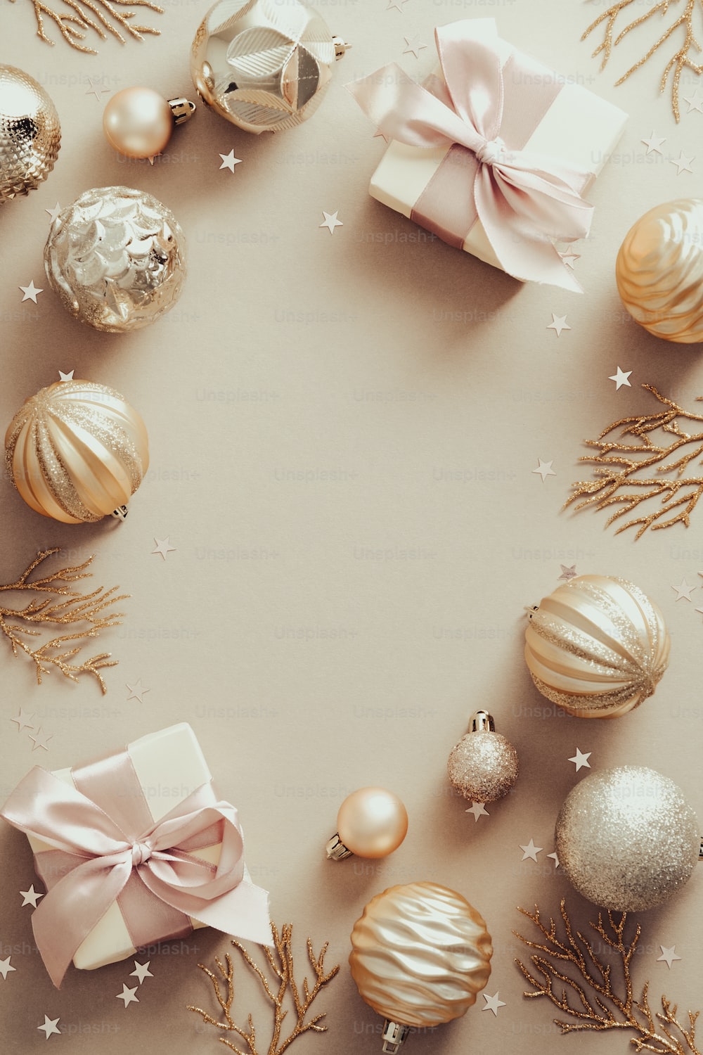 Christmas composition. Frame made of golden balls and gift boxes on pastel beige background. Flat lay, top view. photo
