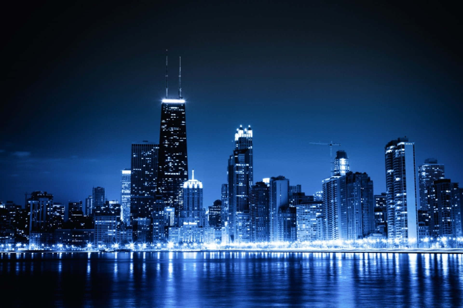 Download Chicago City Night Skyline With Blue Lights Wallpaper