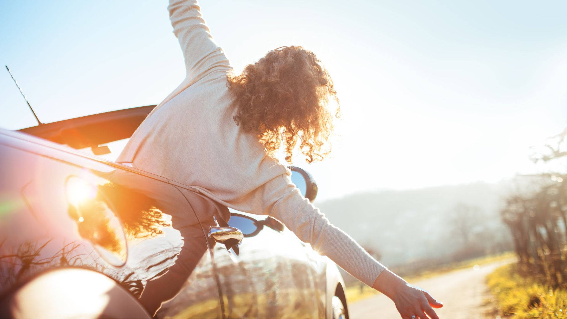 Download Embracing Solitude: A Woman's Road Trip Journey Wallpaper