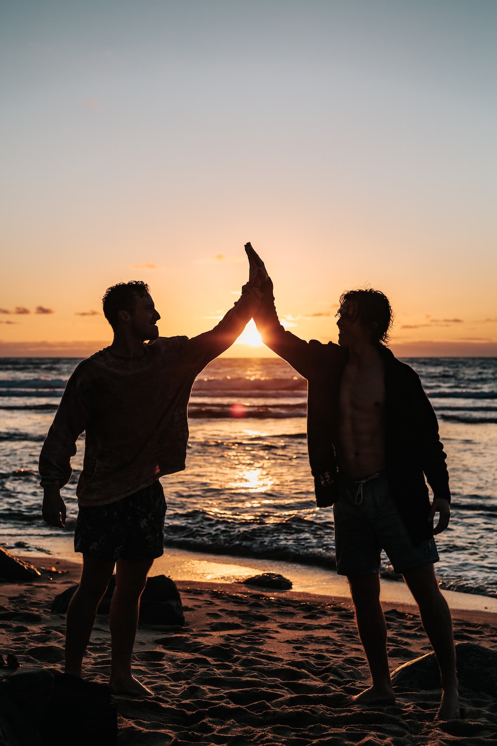 Two men clapping each other on shore photo