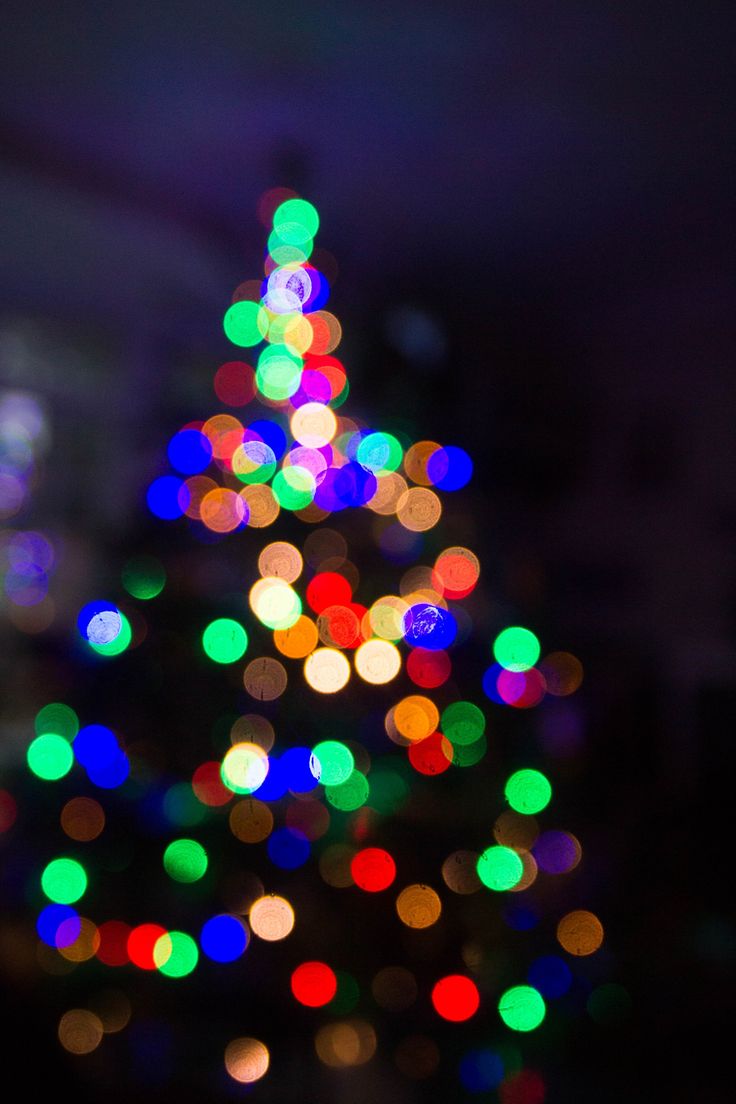 The Out Of Focus, Festive Lights On A Christmas Tree Create A Visual Blur Of Dark And L. Christmas Phone Wallpaper, Holiday Wallpaper, Christmas Traditions Family
