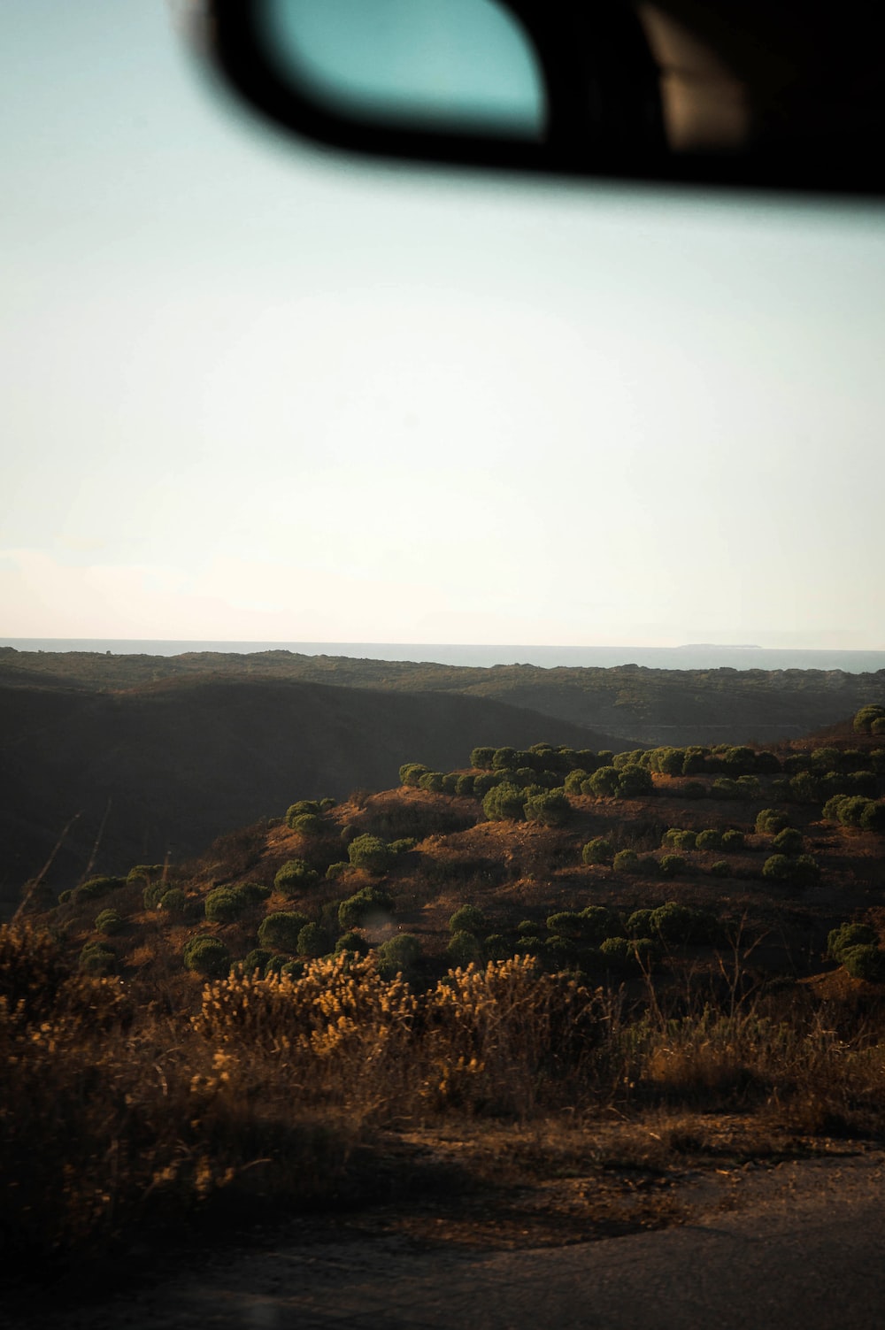 A view from a vehicle of a hilly area photo
