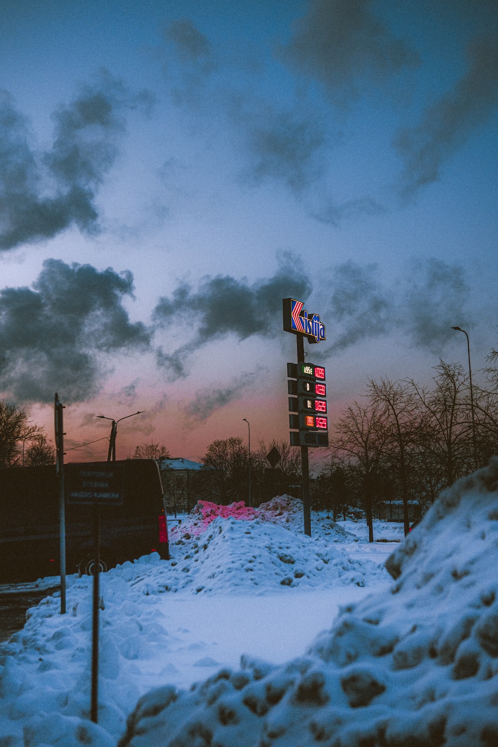 Red and white stop sign under gray clouds photo