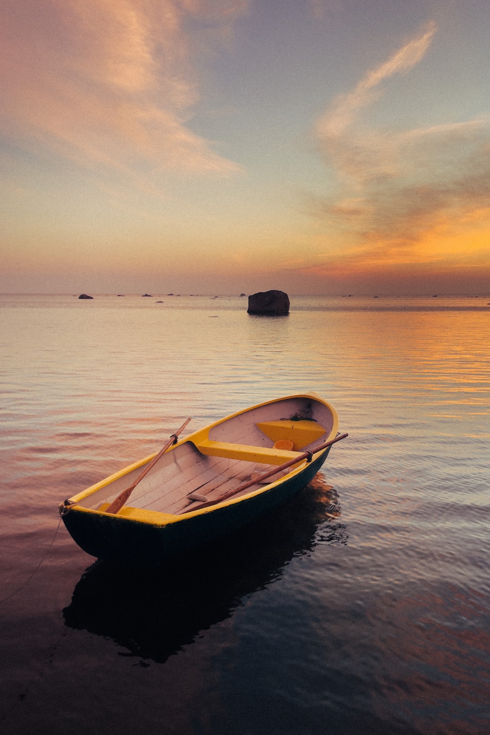 A small boat floating on top of a body of water photo