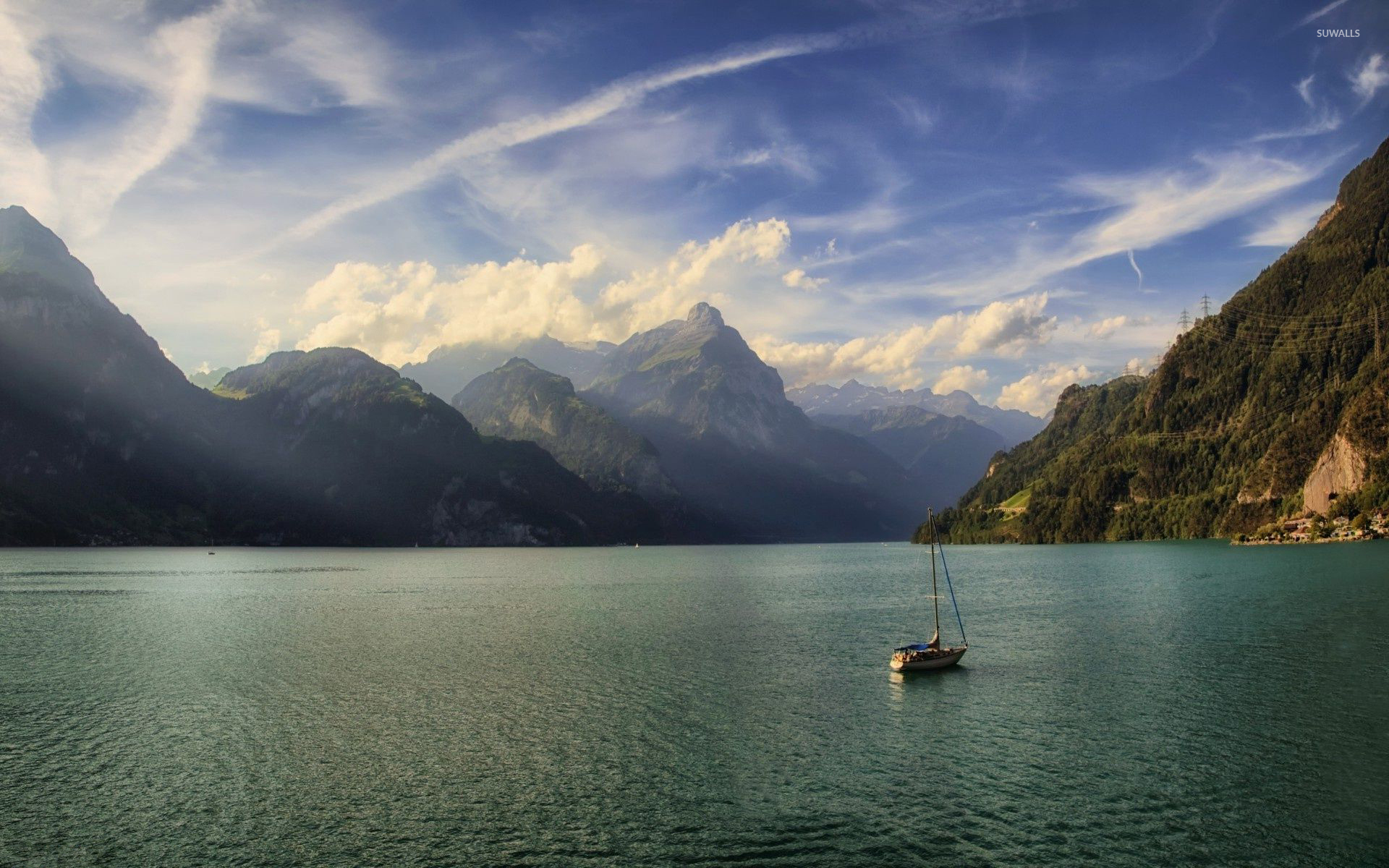Lonesome small boat on the lake surrounded by the mountains wallpaper wallpaper