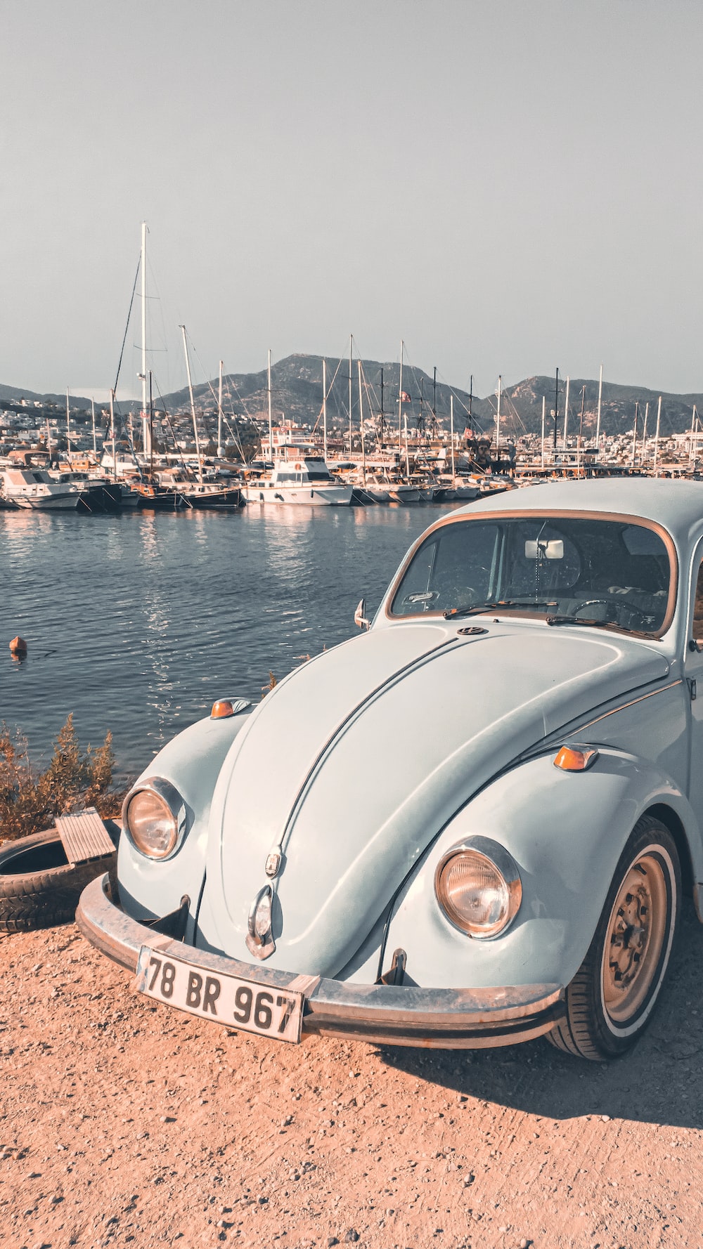 An old vw bug is parked on the beach photo