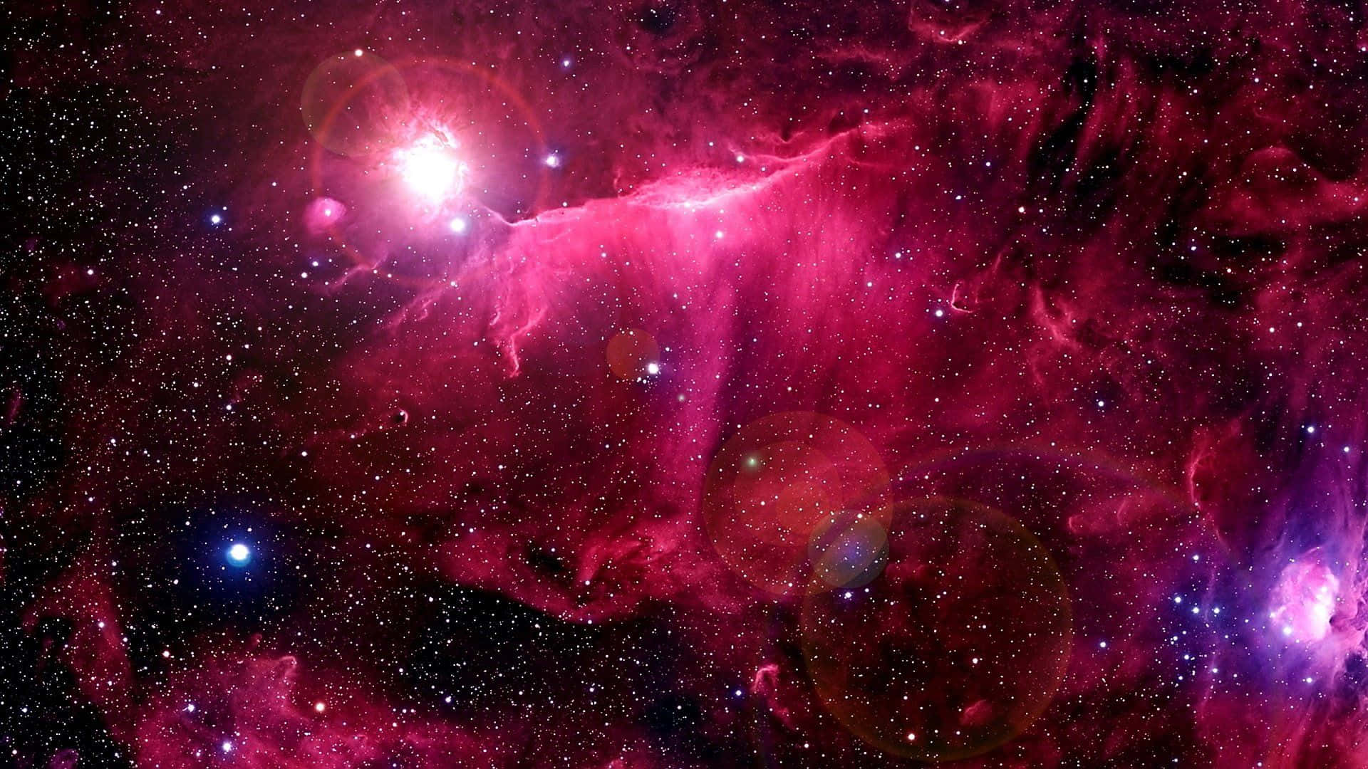 Download A Pink Nebula With Stars