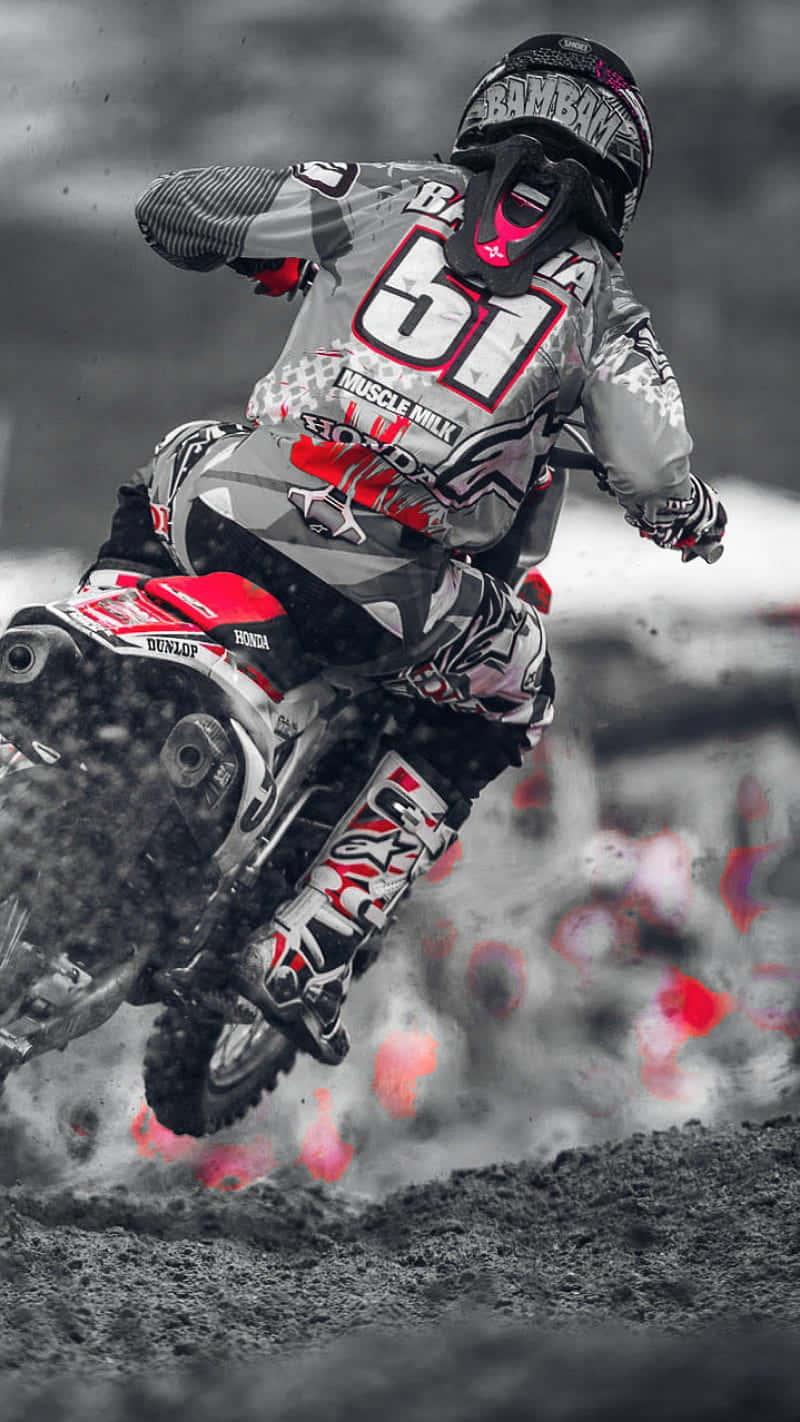 Download A Person Riding A Dirt Bike Wallpaper