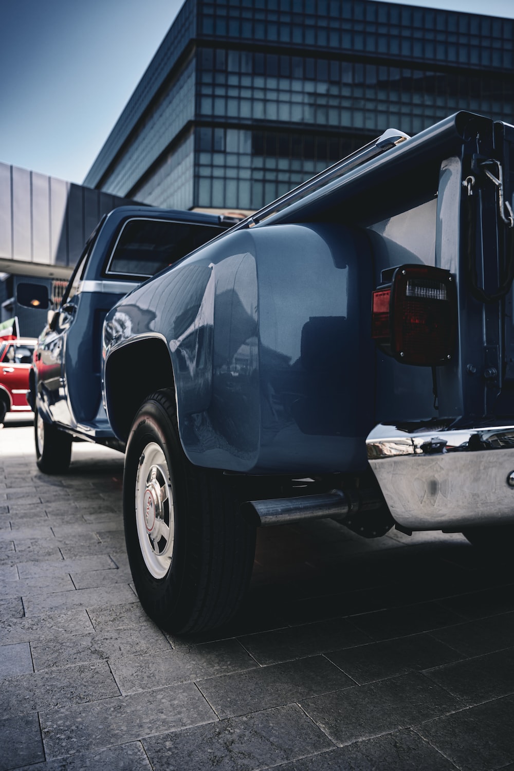 A blue pick up truck parked in front of a building photo