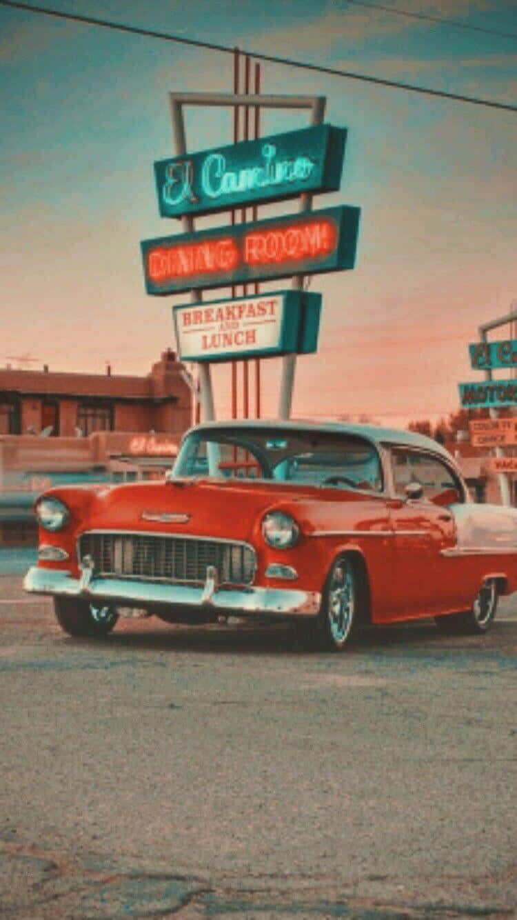 Download Take a ride in beauty and nostalgia with a Vintage Car iPhone. Wallpaper